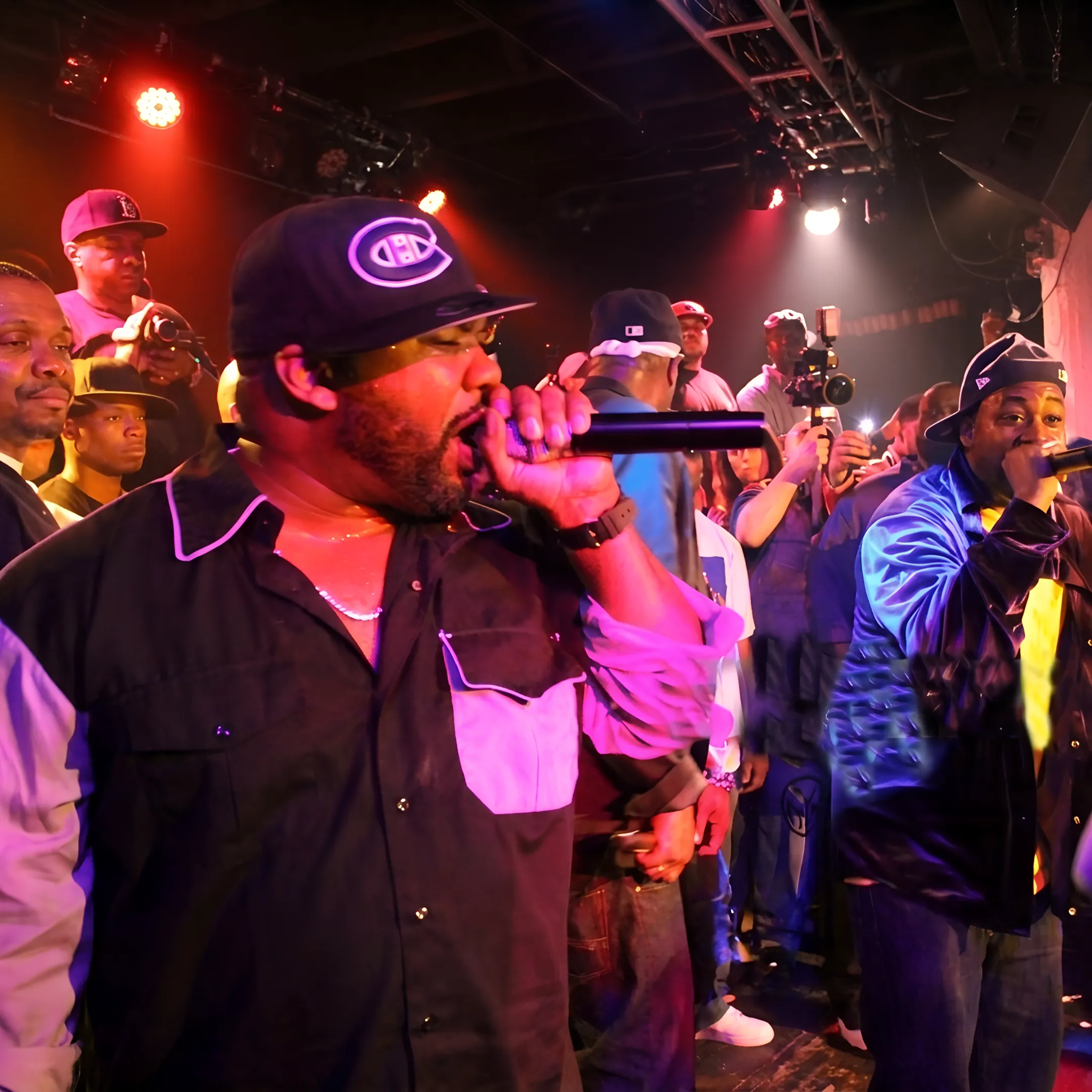 Event professional coordinating a rapper performance backstage at a live music venue