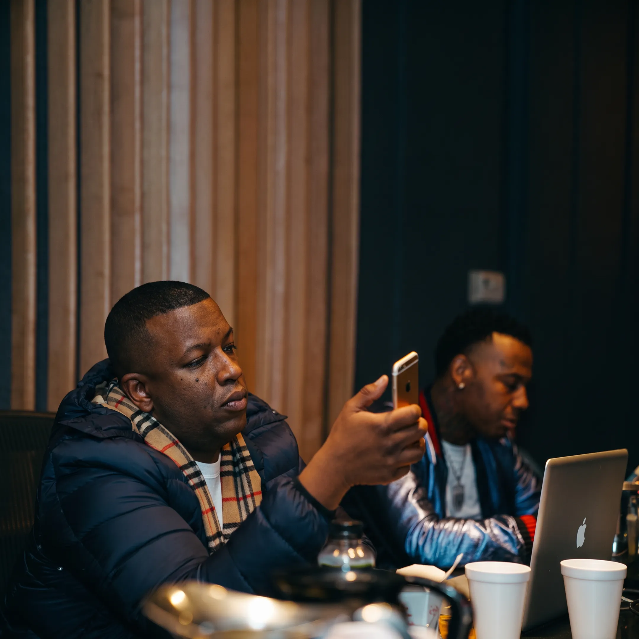 Booking professional discussing a hip hop performance with an artist
