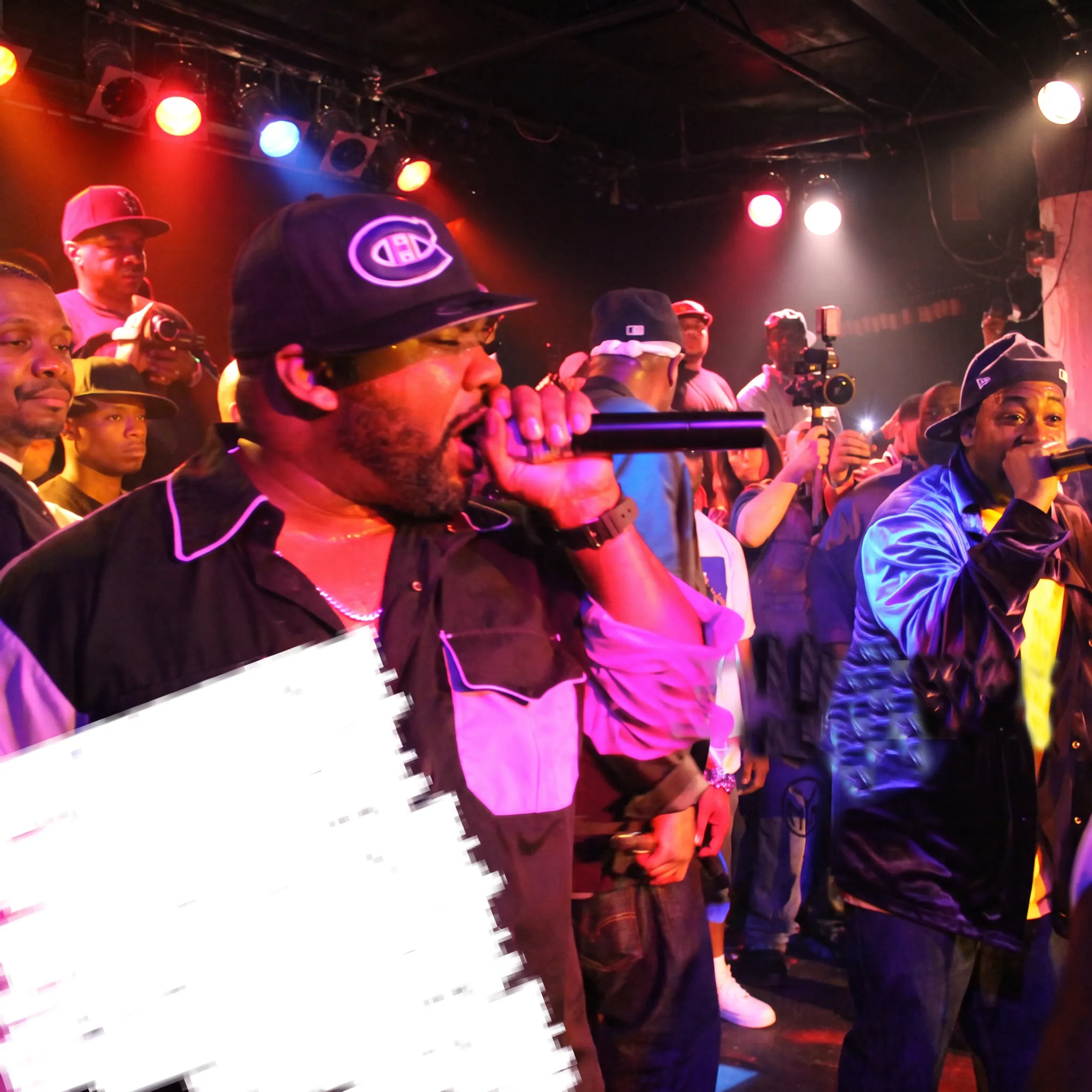 Hip hop artist performing onstage before an energetic live audience