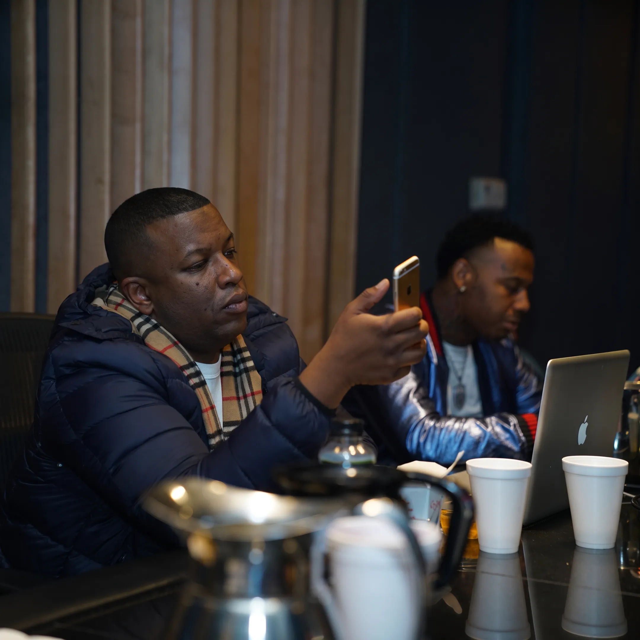 Entertainment professional advising recording artist during a creative development meeting