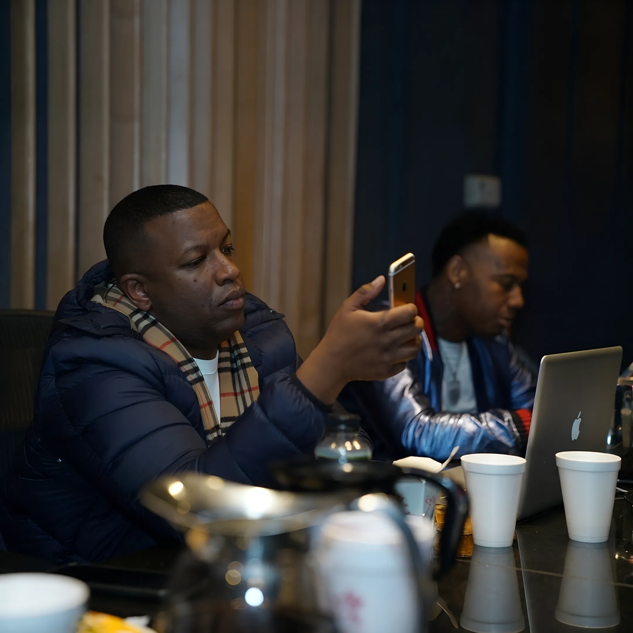 Rap artist and manager planning a music promotion campaign together