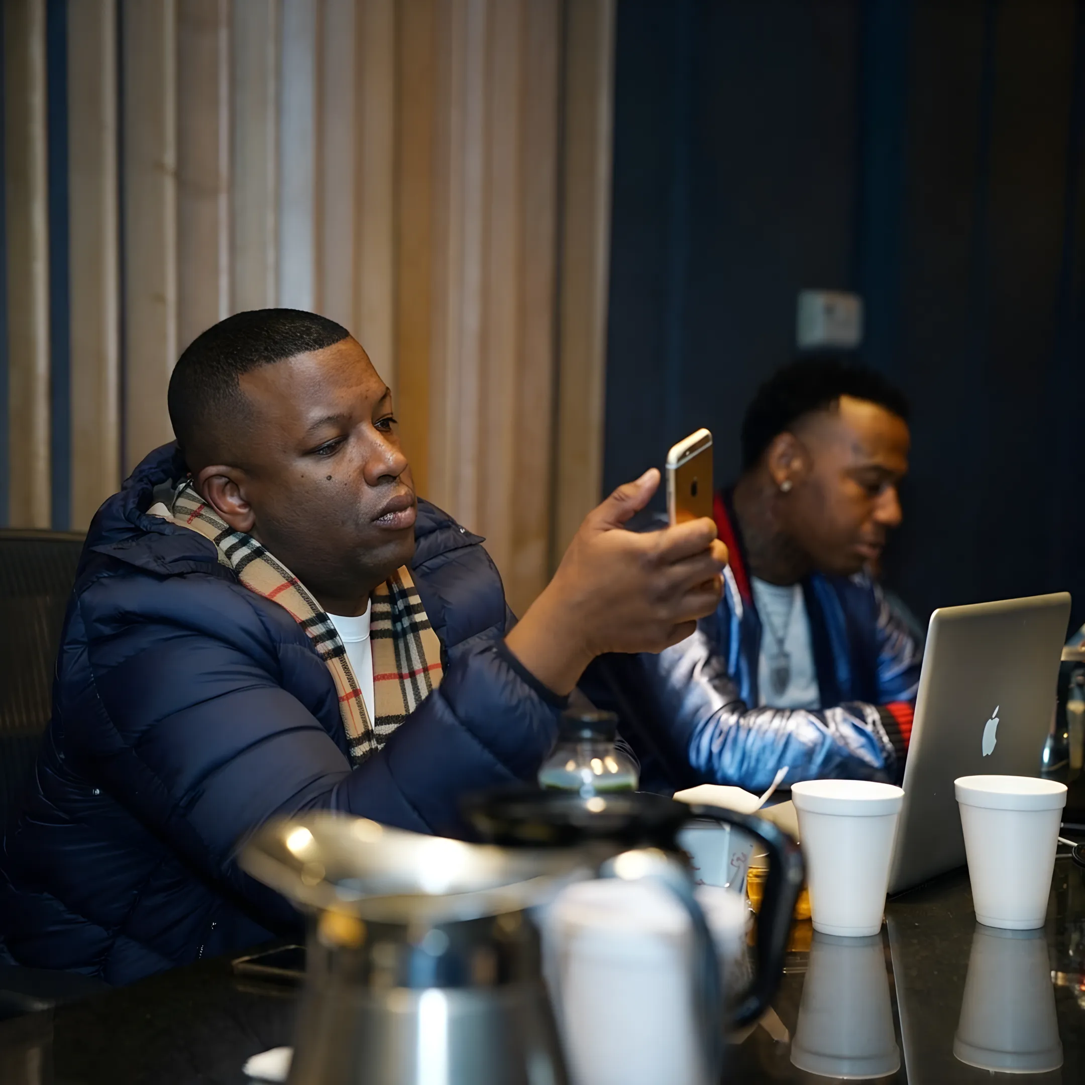 Artist promotion strategy session with campaign planning documents and music branding materials
