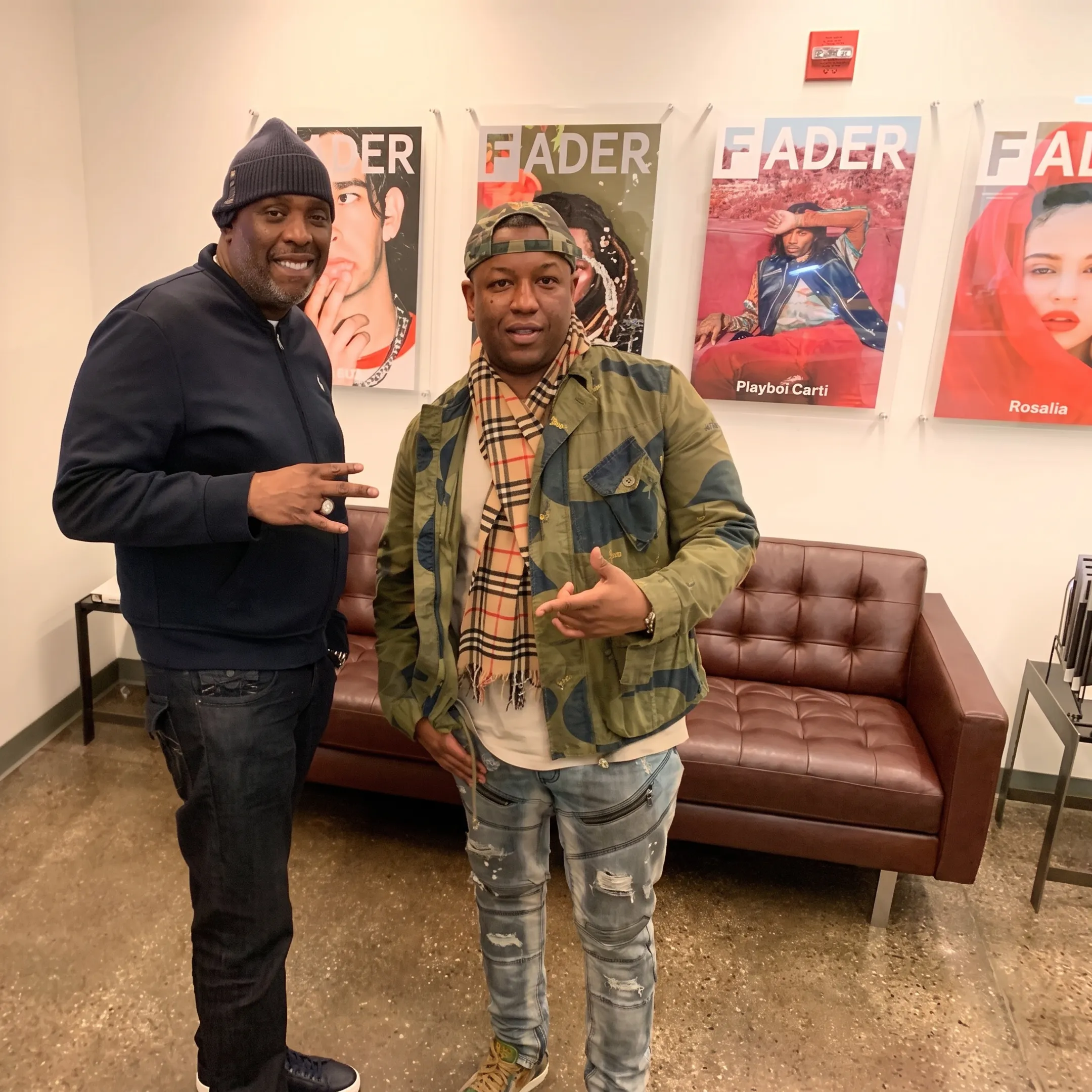 Artist and consultant discussing a rap release strategy at a studio table