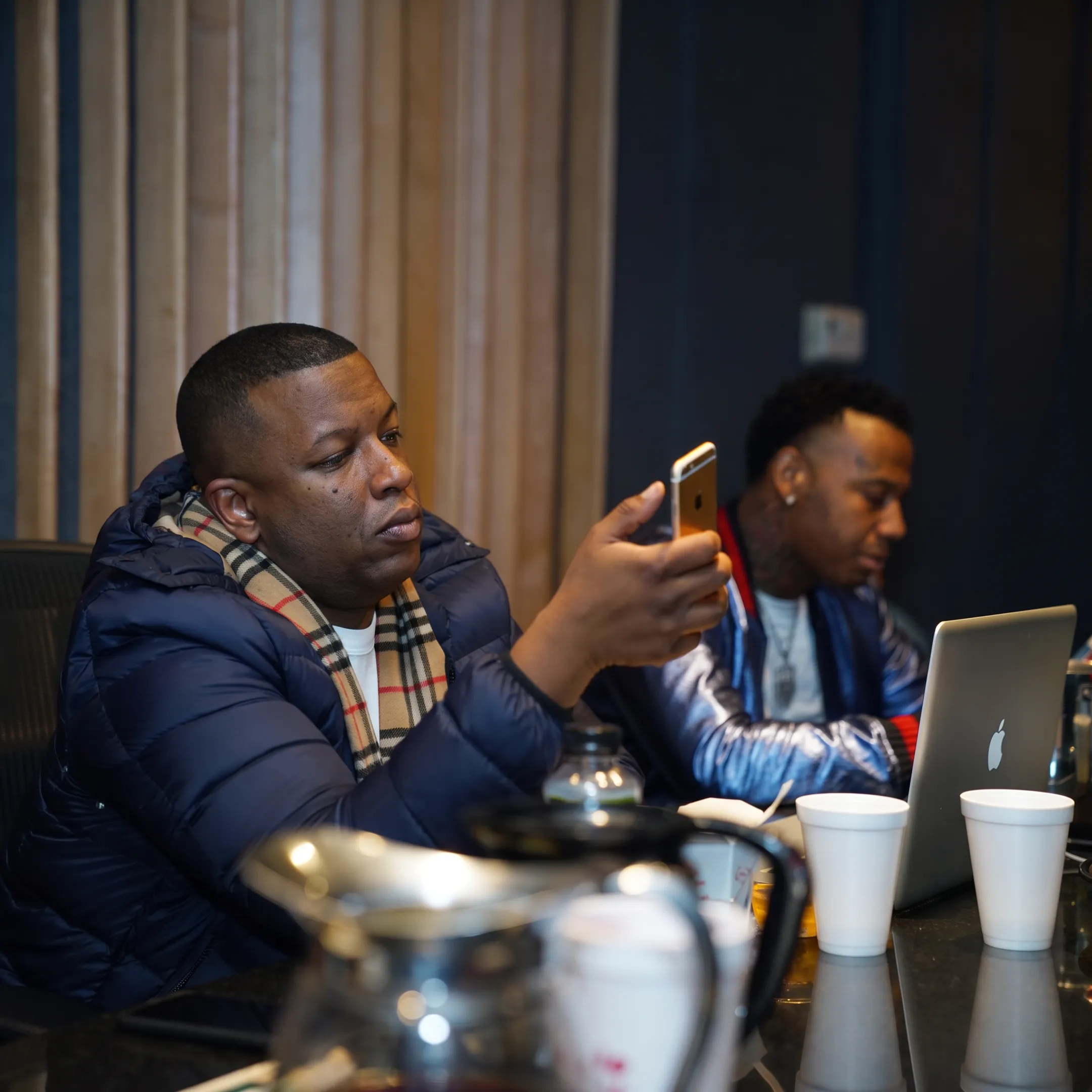 Rapper working with an entertainment career consultant in a professional studio