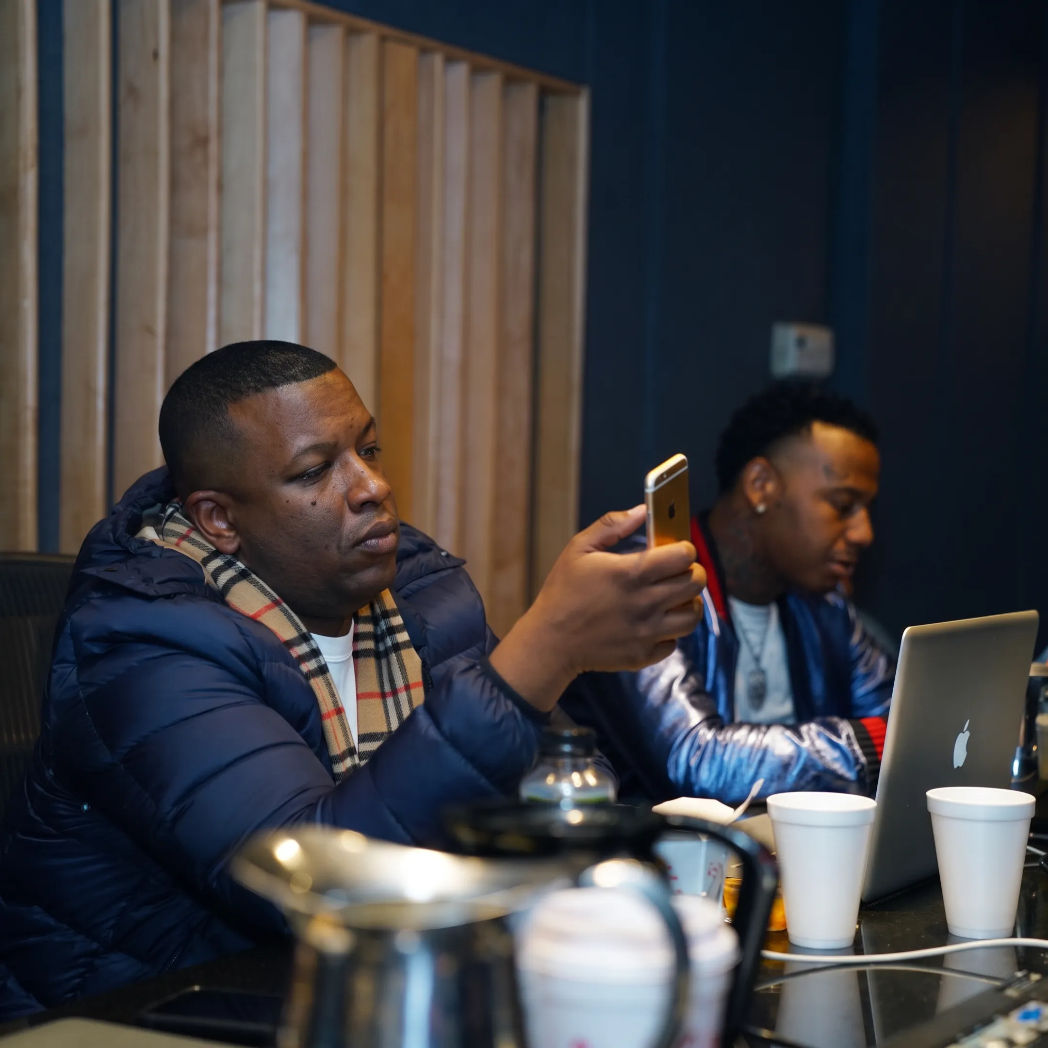 Rapper and music marketing consultant discussing release strategy in a studio