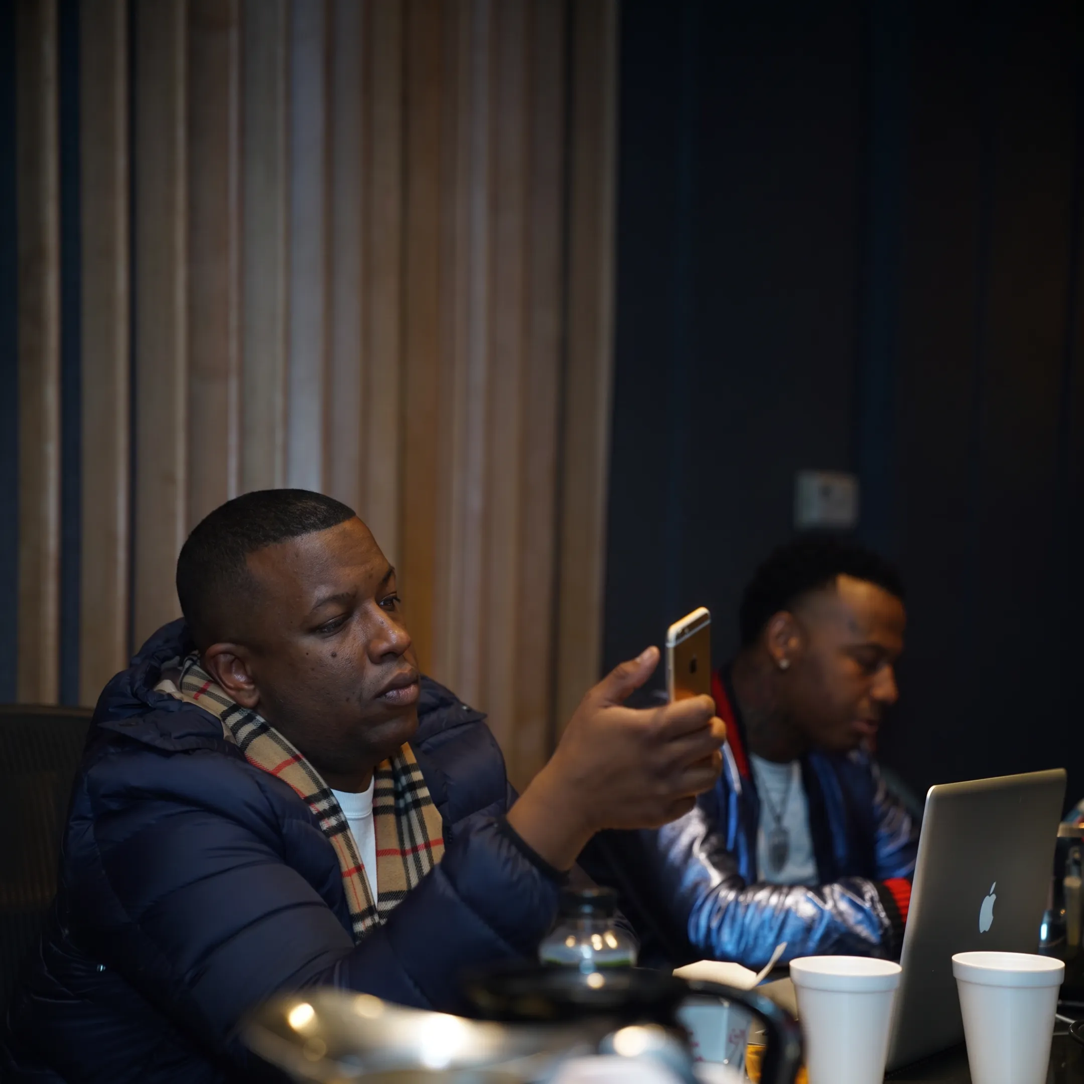 Rap artist meeting with an experienced manager in a modern music studio