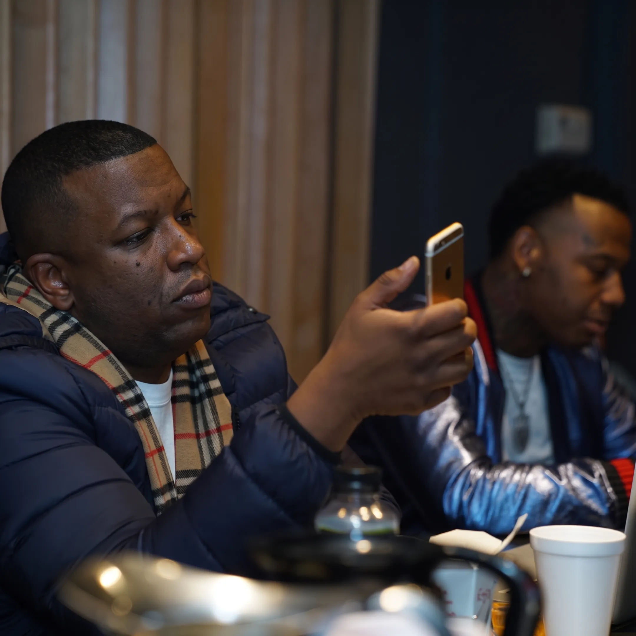 Music manager discussing an artist release plan with a rap performer