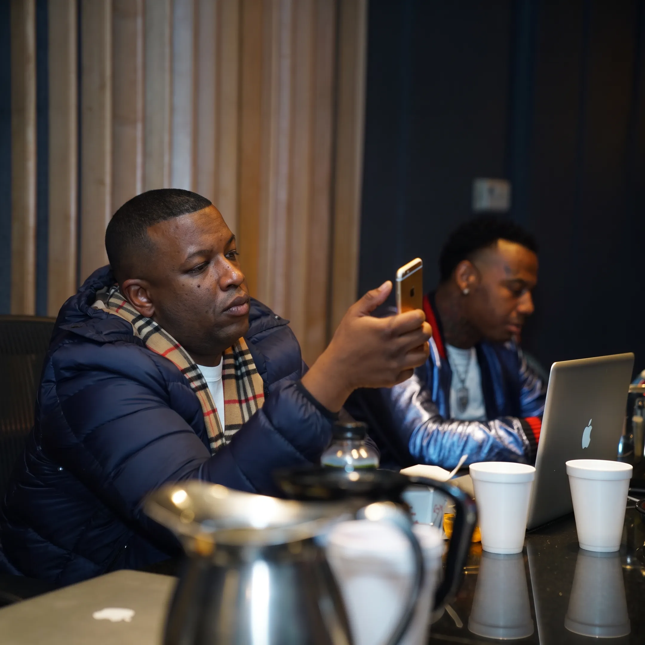 Independent artist reviewing music promotion plans with an entertainment strategist in a creative studio