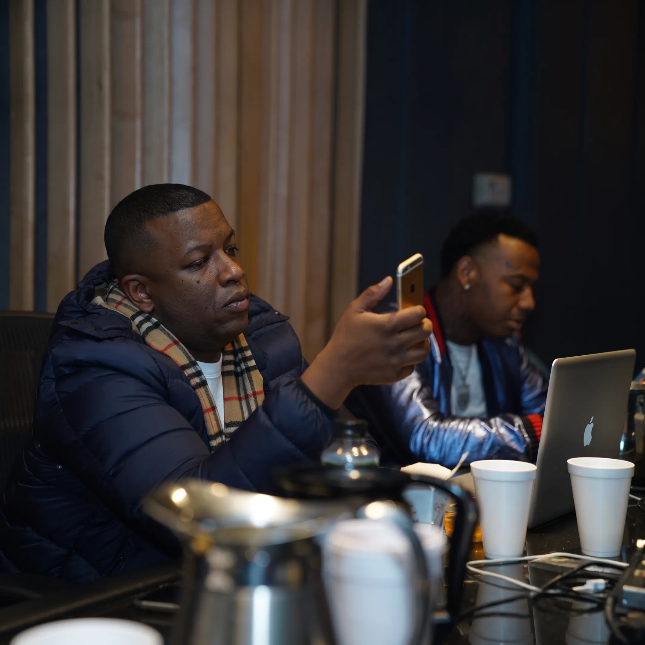 Music professional discussing DJ performance bookings with an artist in a Los Angeles studio