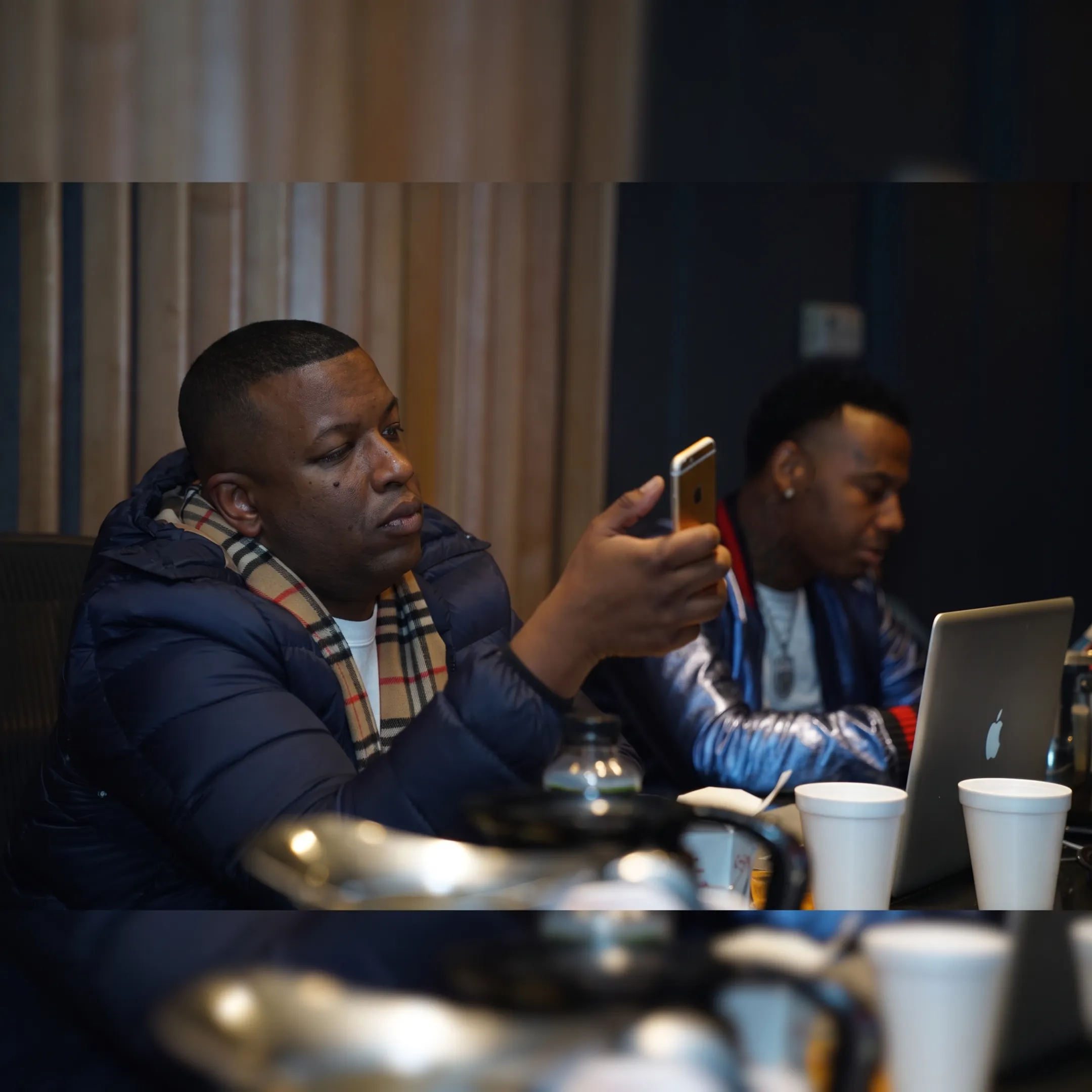 Entertainment professional discussing booking strategy with an independent artist in a recording studio