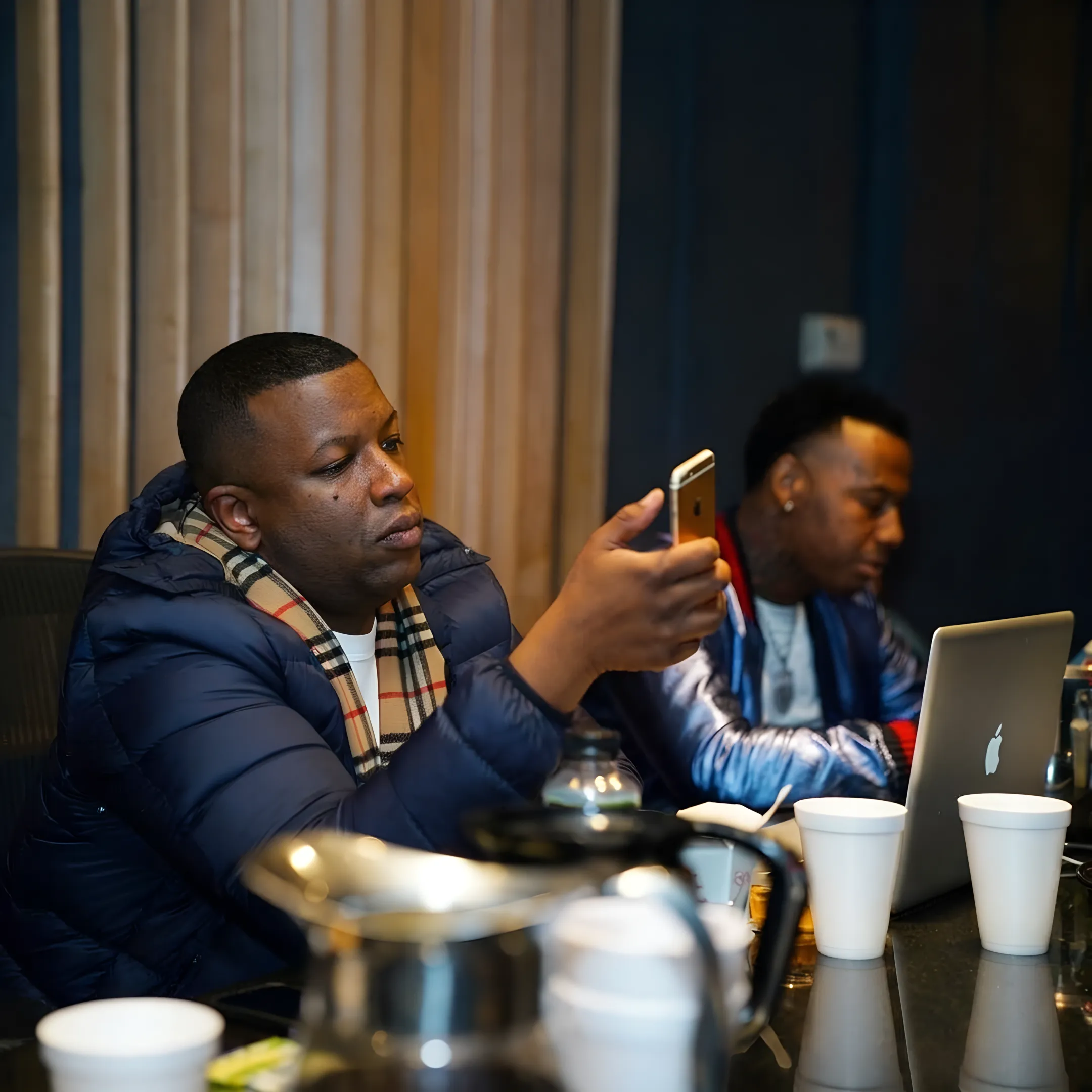 Music industry professional reviewing rap artist booking plans with an artist