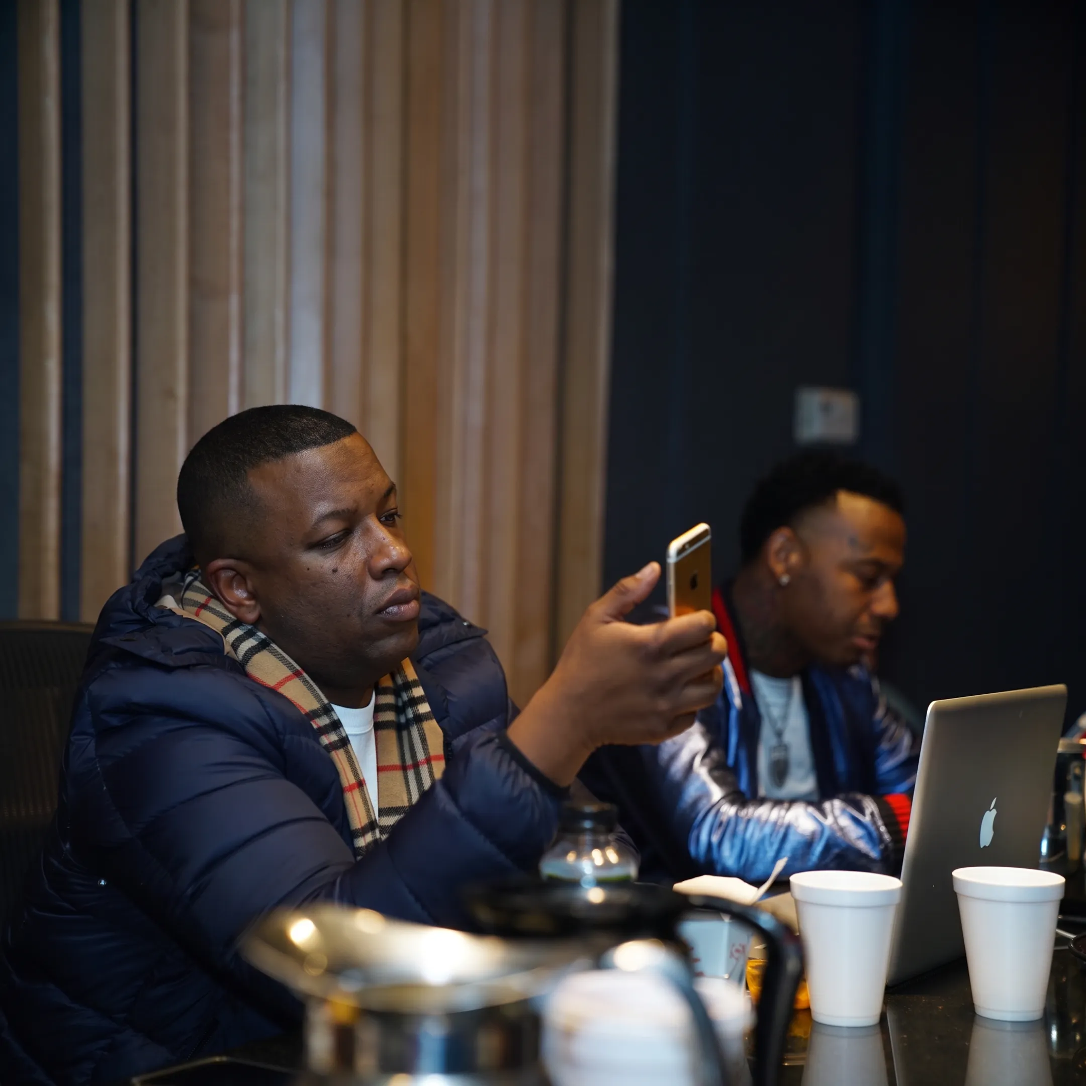 Artist manager advising an independent musician during a focused music industry planning meeting