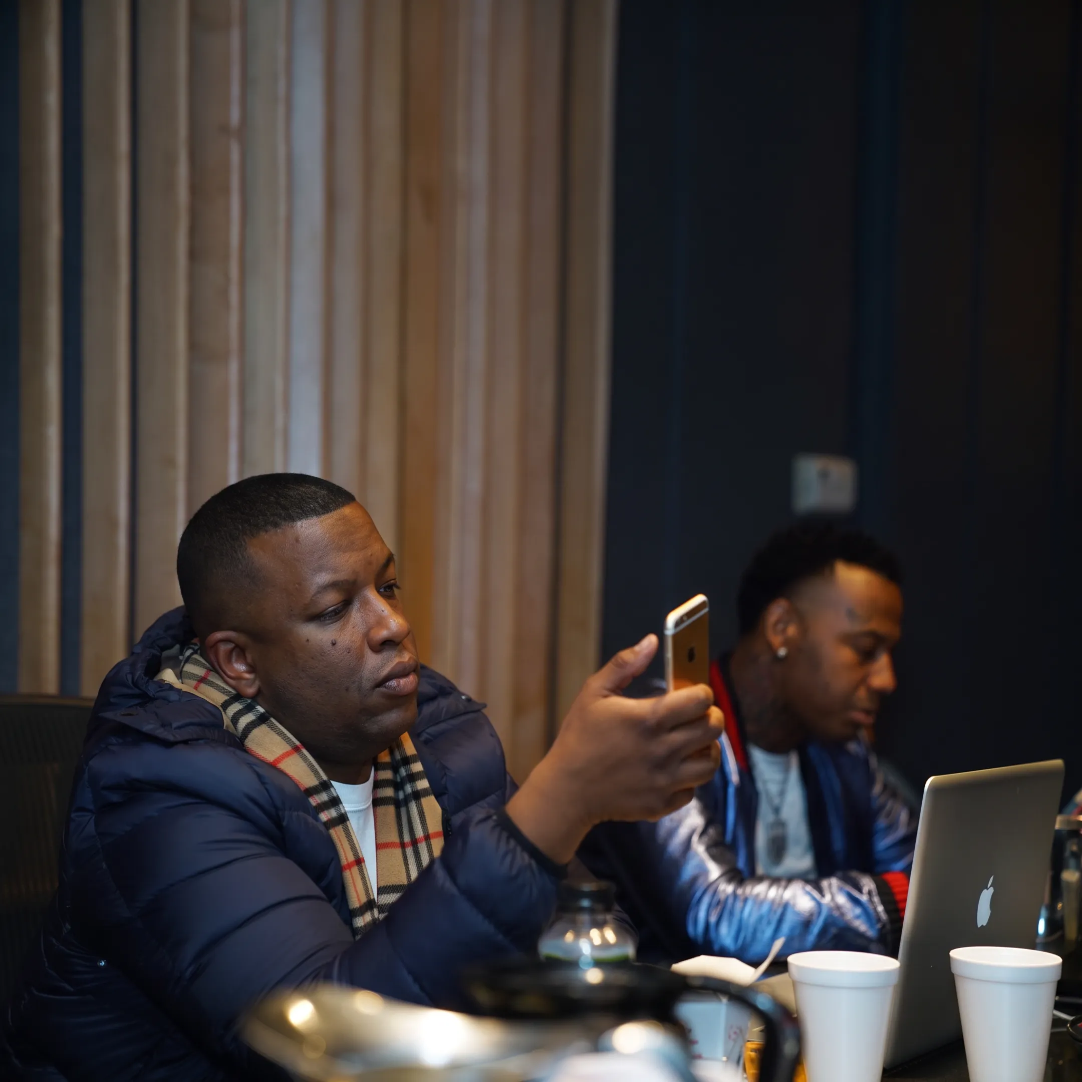 Independent artist reviewing music merchandise and campaign plans with an experienced manager