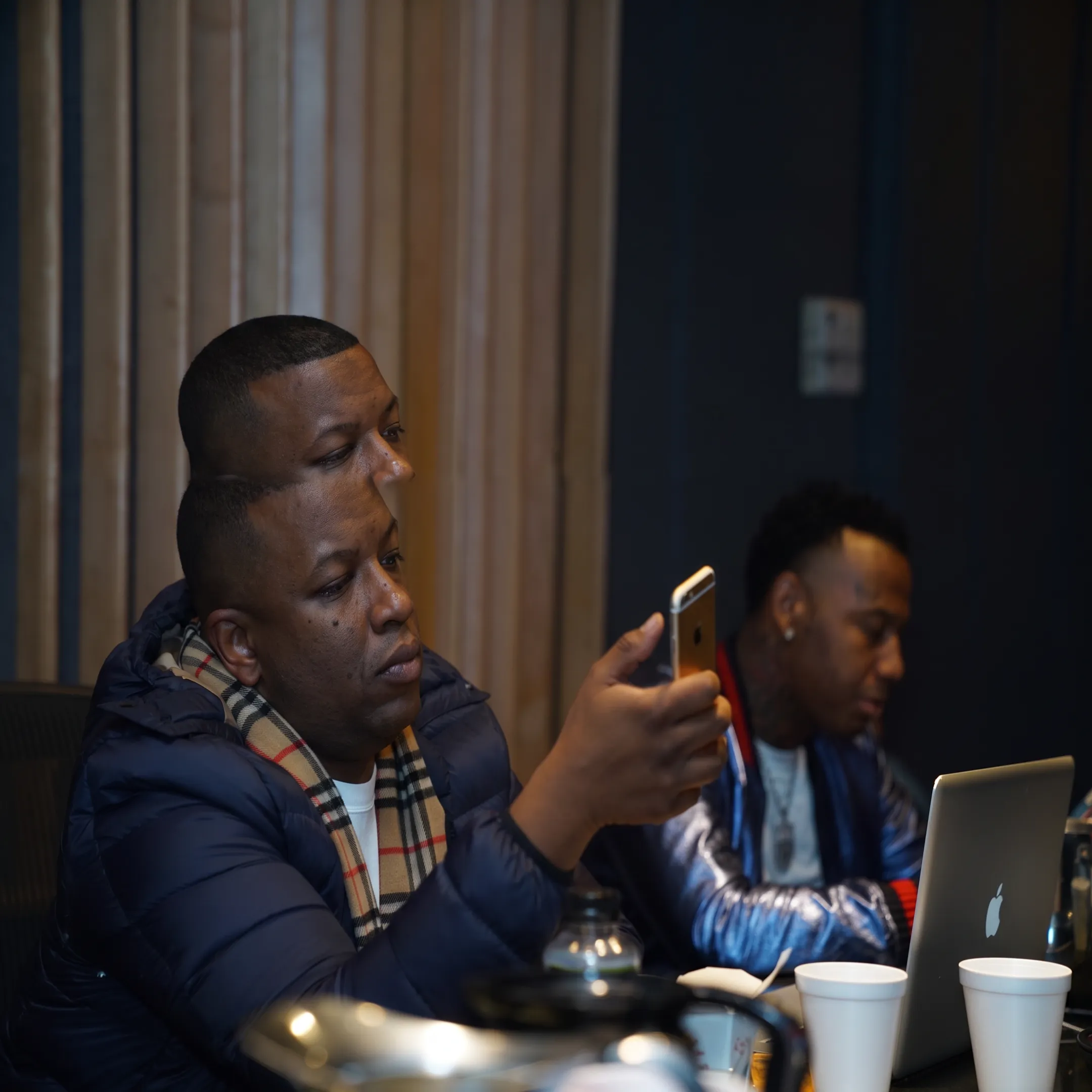 Artist manager reviewing a music strategy with an artist in a Philadelphia studio
