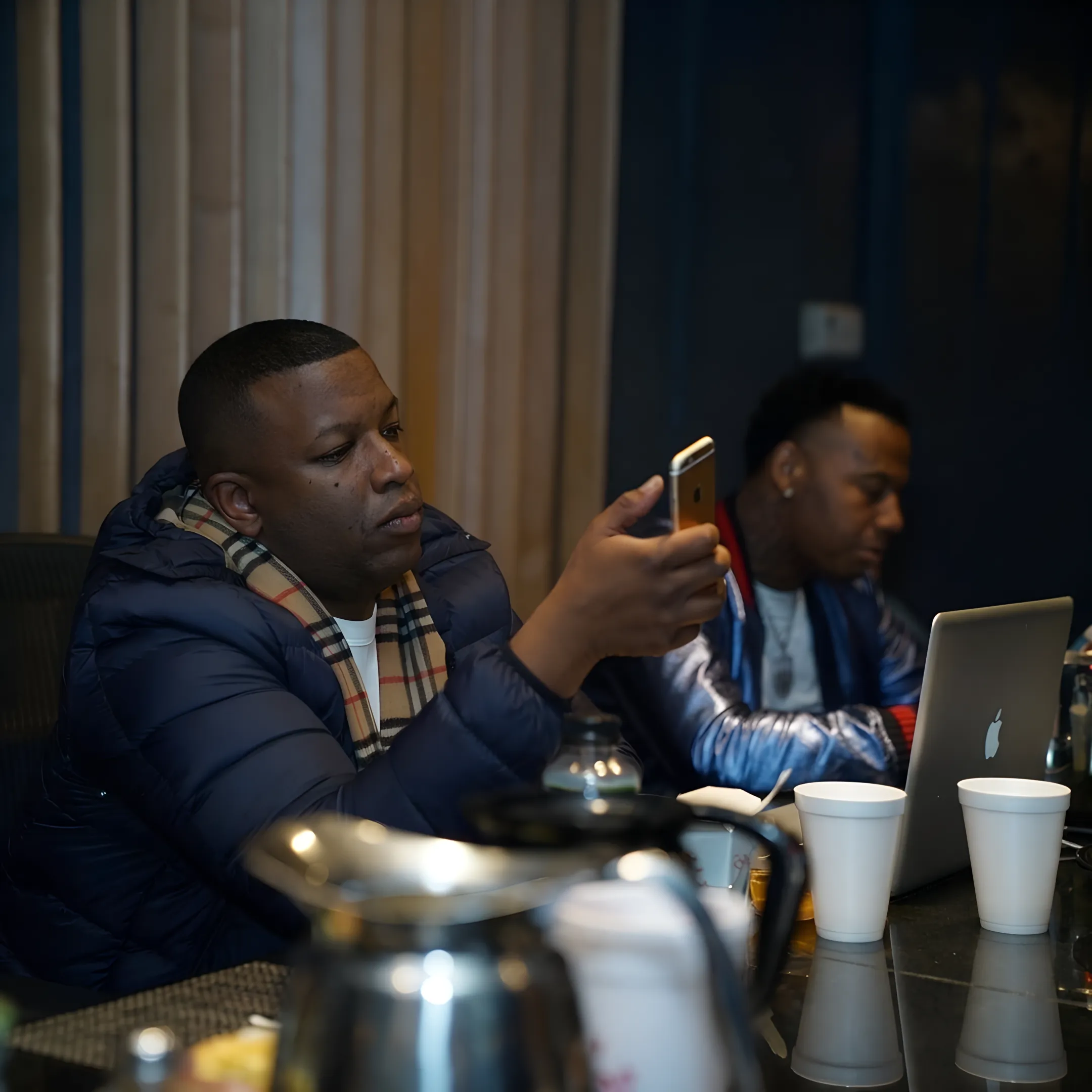 Artist marketing consultant discussing a release strategy with a musician and reviewing campaign visuals