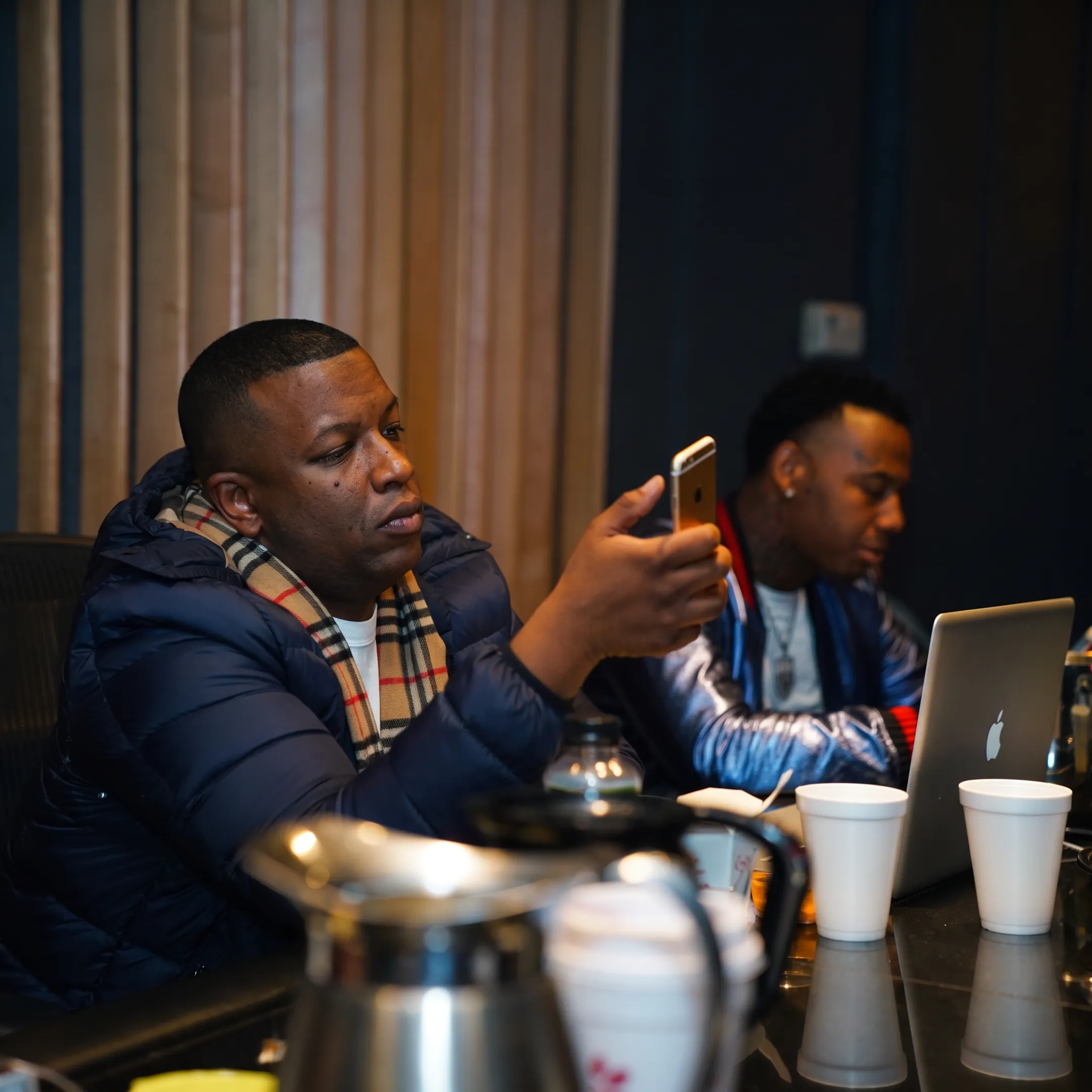 Music manager reviewing release plans with an artist in a professional studio