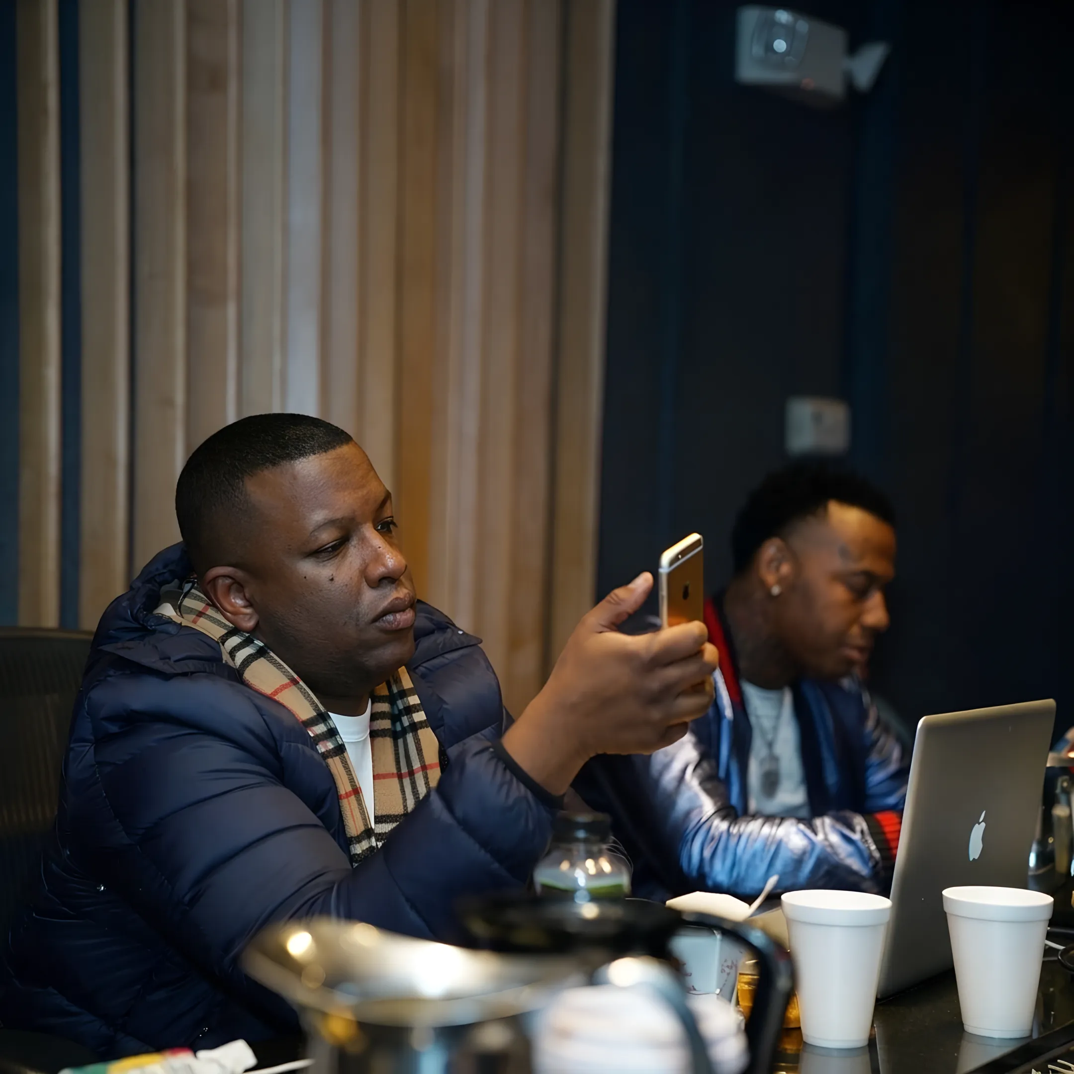Rap manager advising Atlanta artist during a focused music strategy meeting