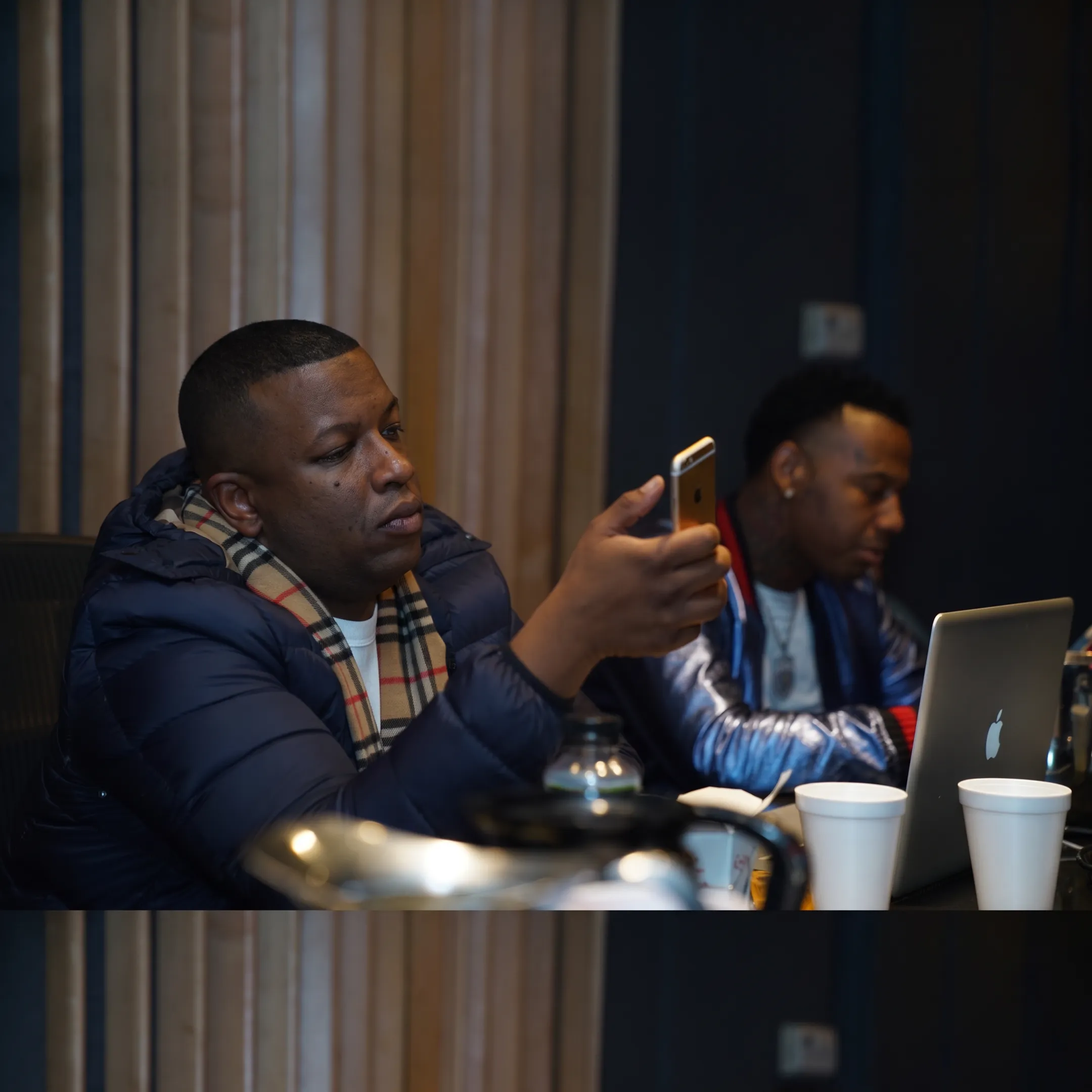 Music booking professional discussing tour opportunities with an artist in a studio setting