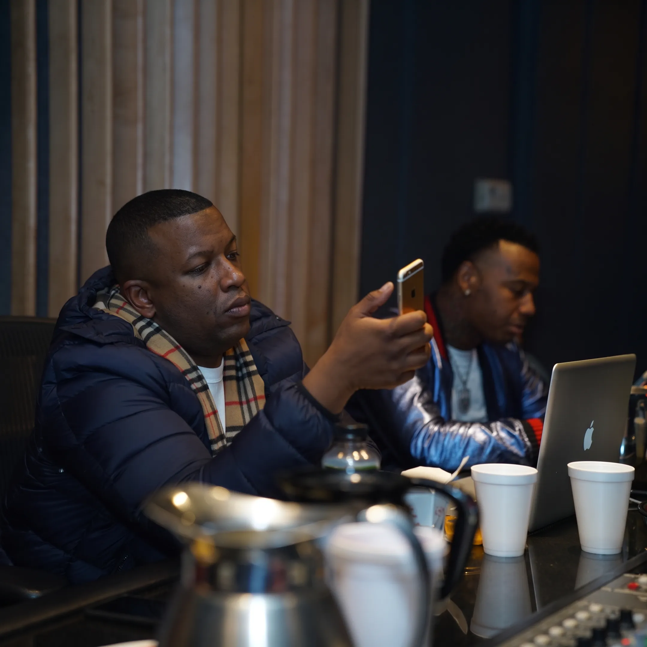 Music manager consulting with an independent artist in a professional studio