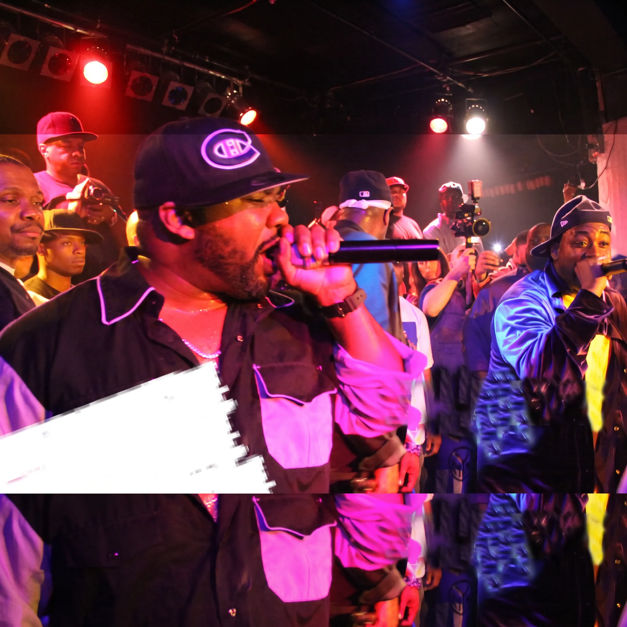 Independent hip-hop artist performing onstage before an engaged live audience