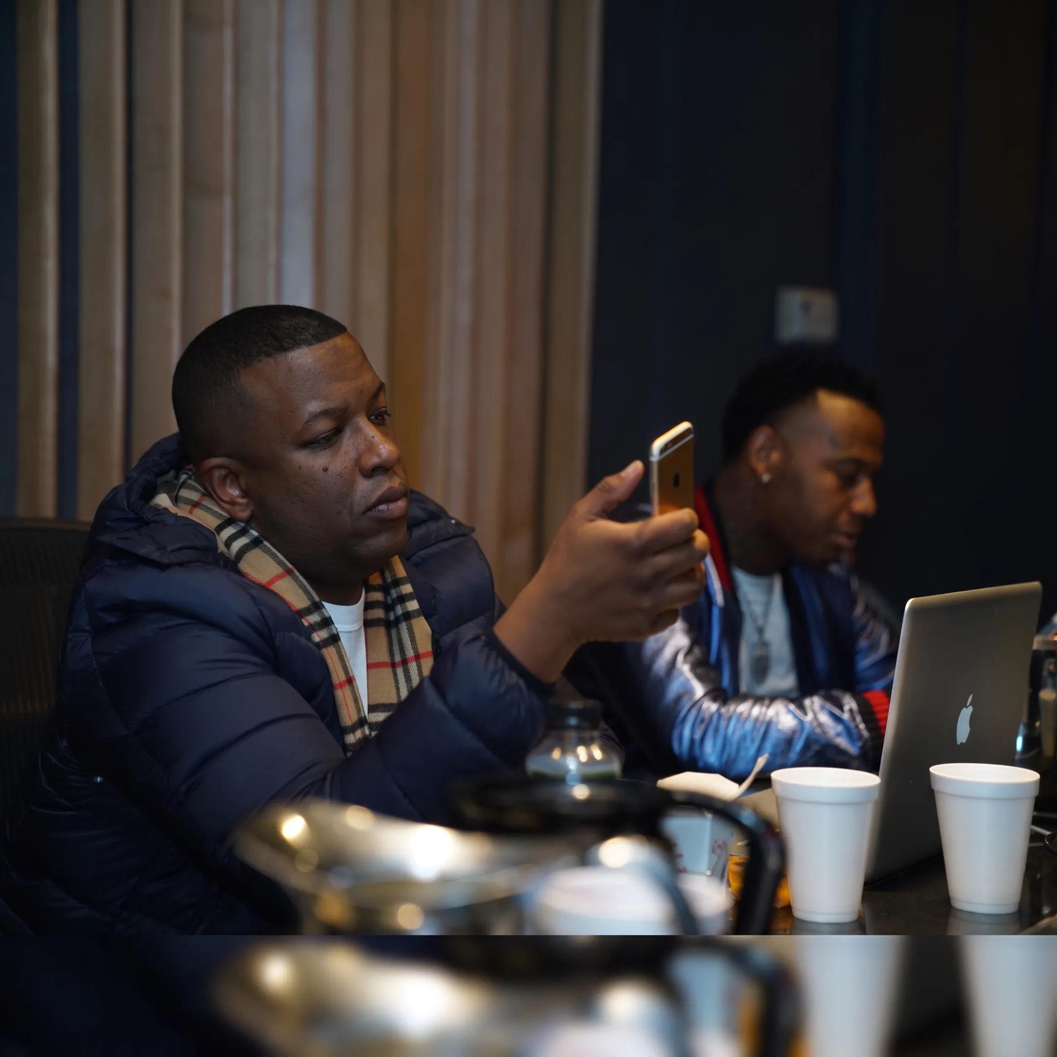 Hip-hop booking professional discussing a live performance opportunity with an independent artist