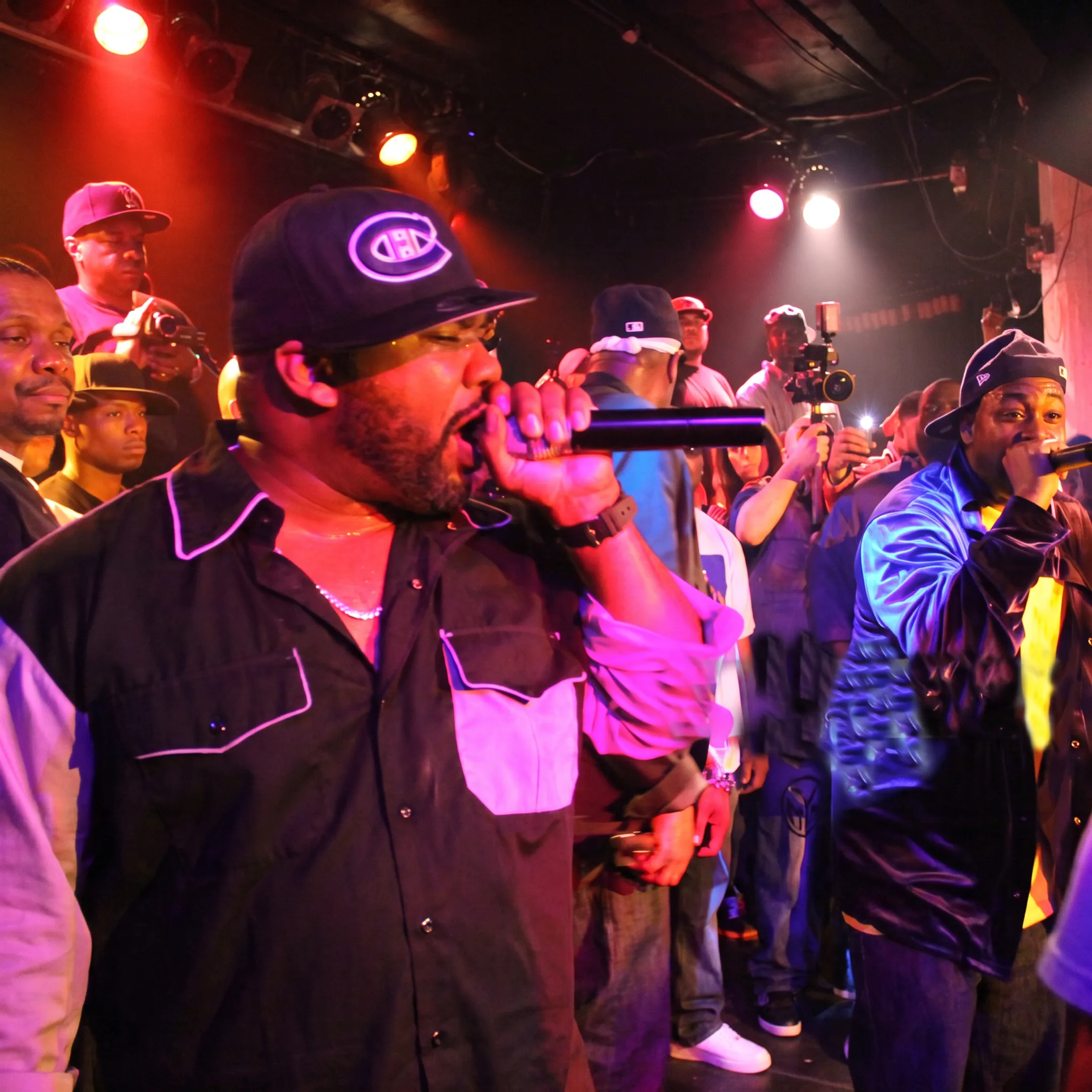Independent hip hop artist performing onstage before an engaged live audience