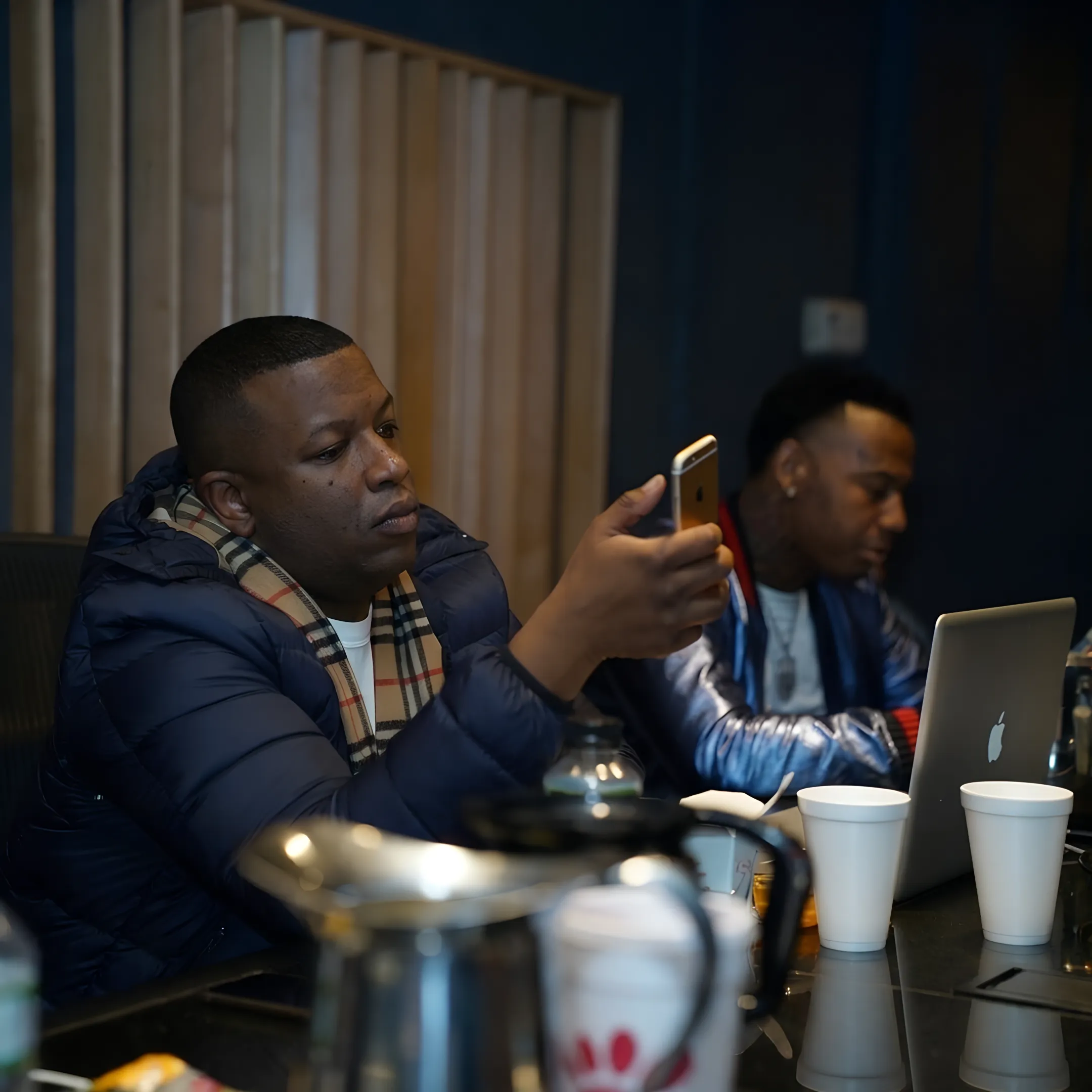 Artist and music manager discussing branding and career strategy in a creative studio
