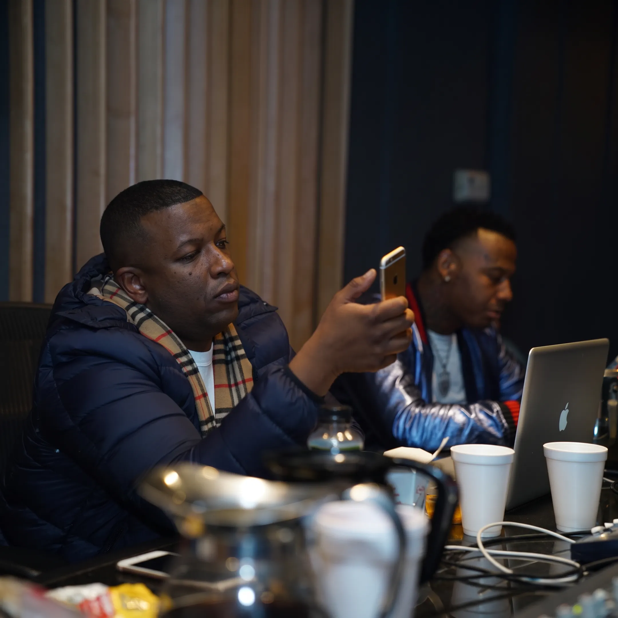 Rap artist creating social media content in a recording studio