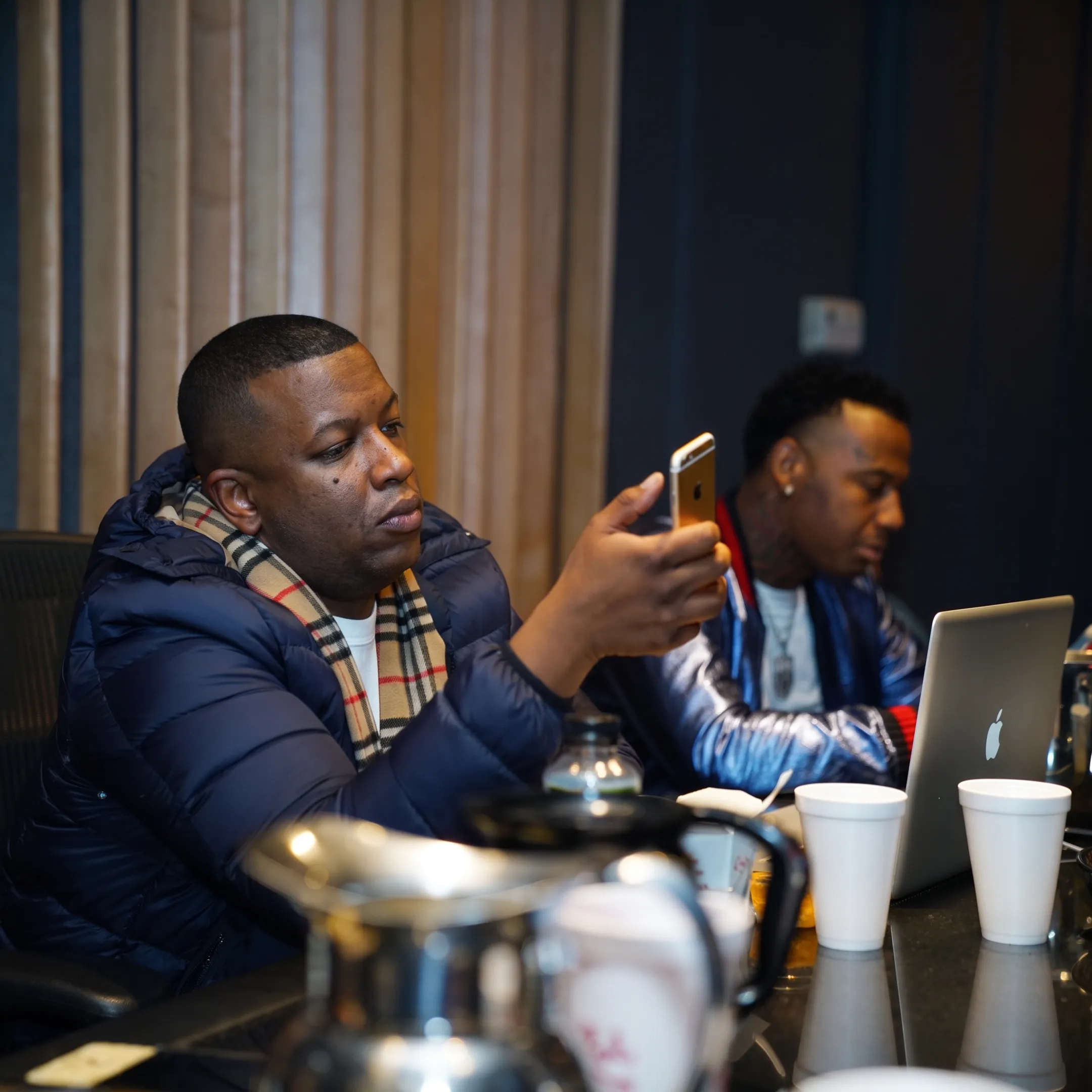 Music manager consulting with an artist in a Raleigh studio