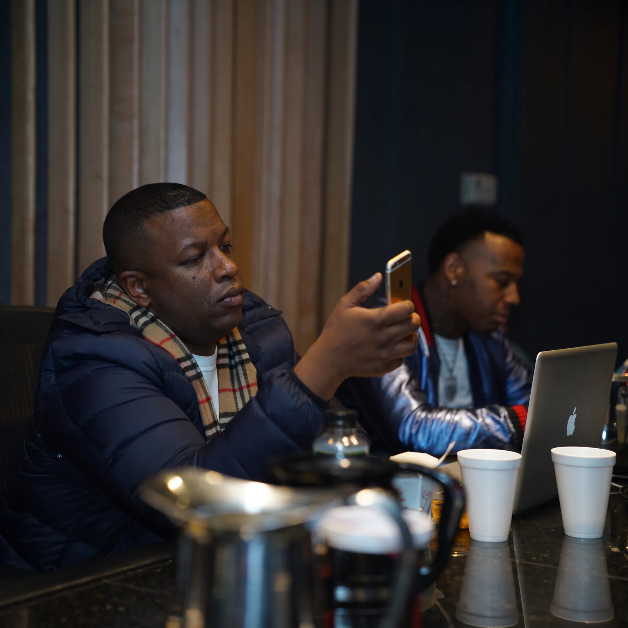 Artist and manager reviewing music career plans during a studio consultation