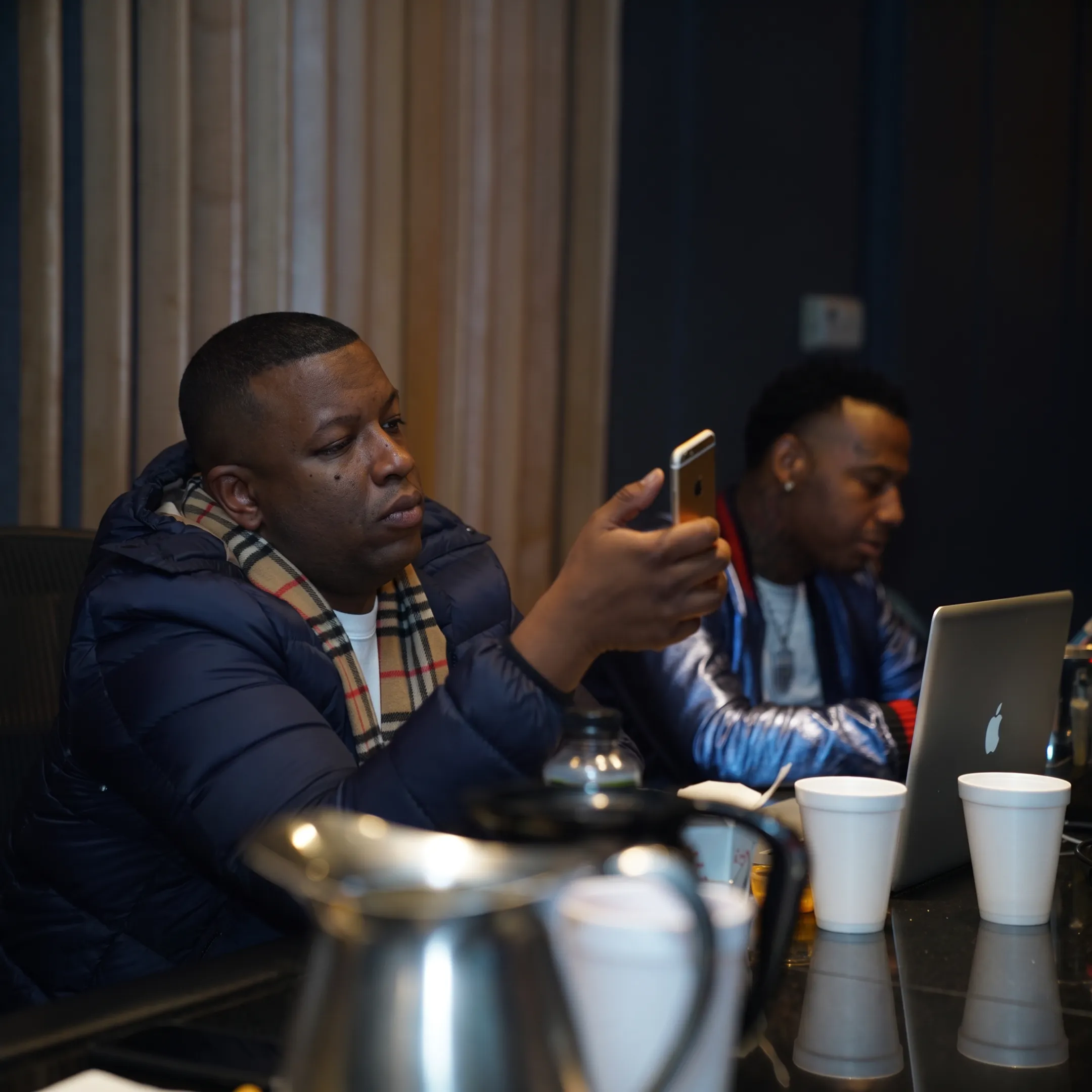 Music manager consulting with an emerging artist in a recording studio