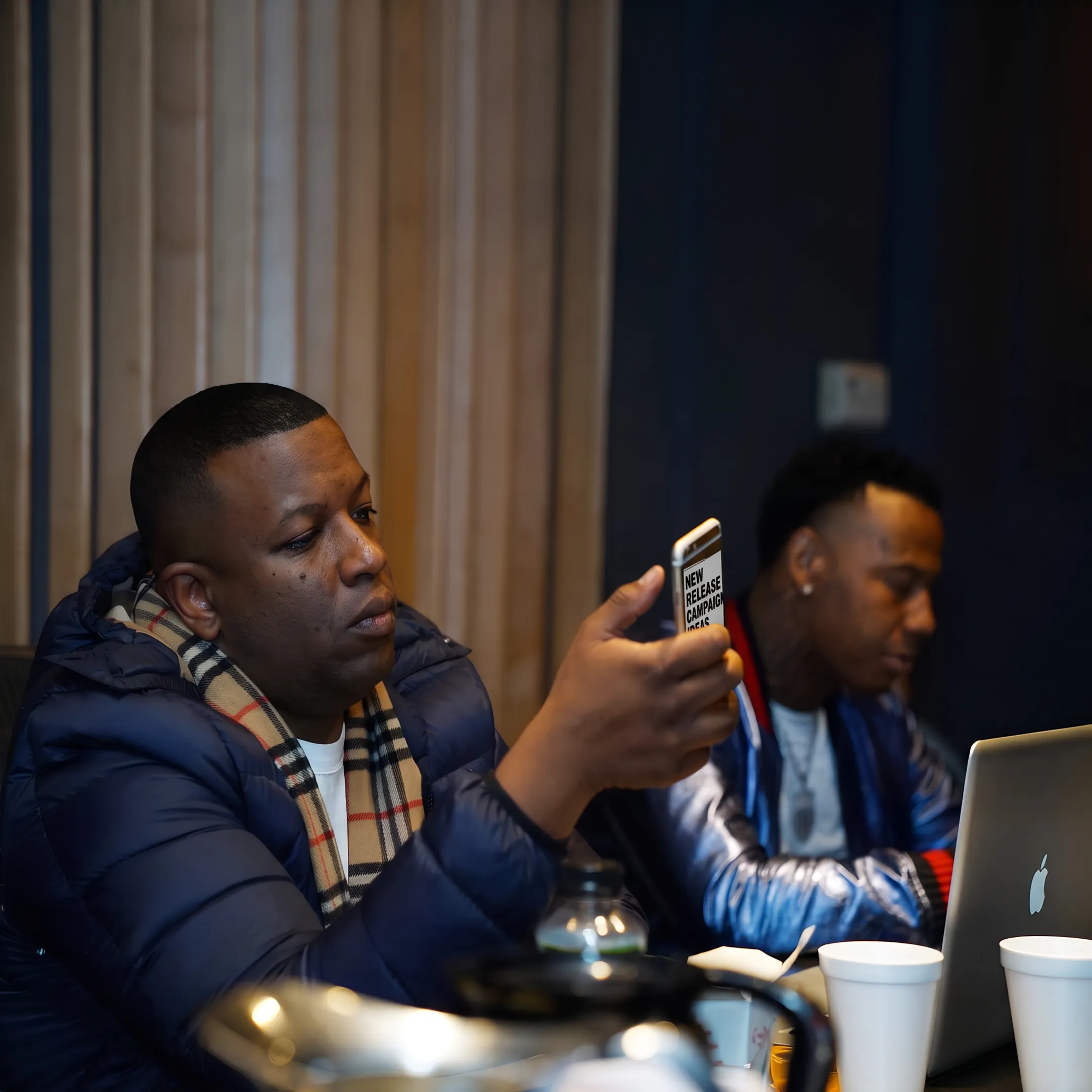 Artist reviewing a social media campaign with an entertainment consultant