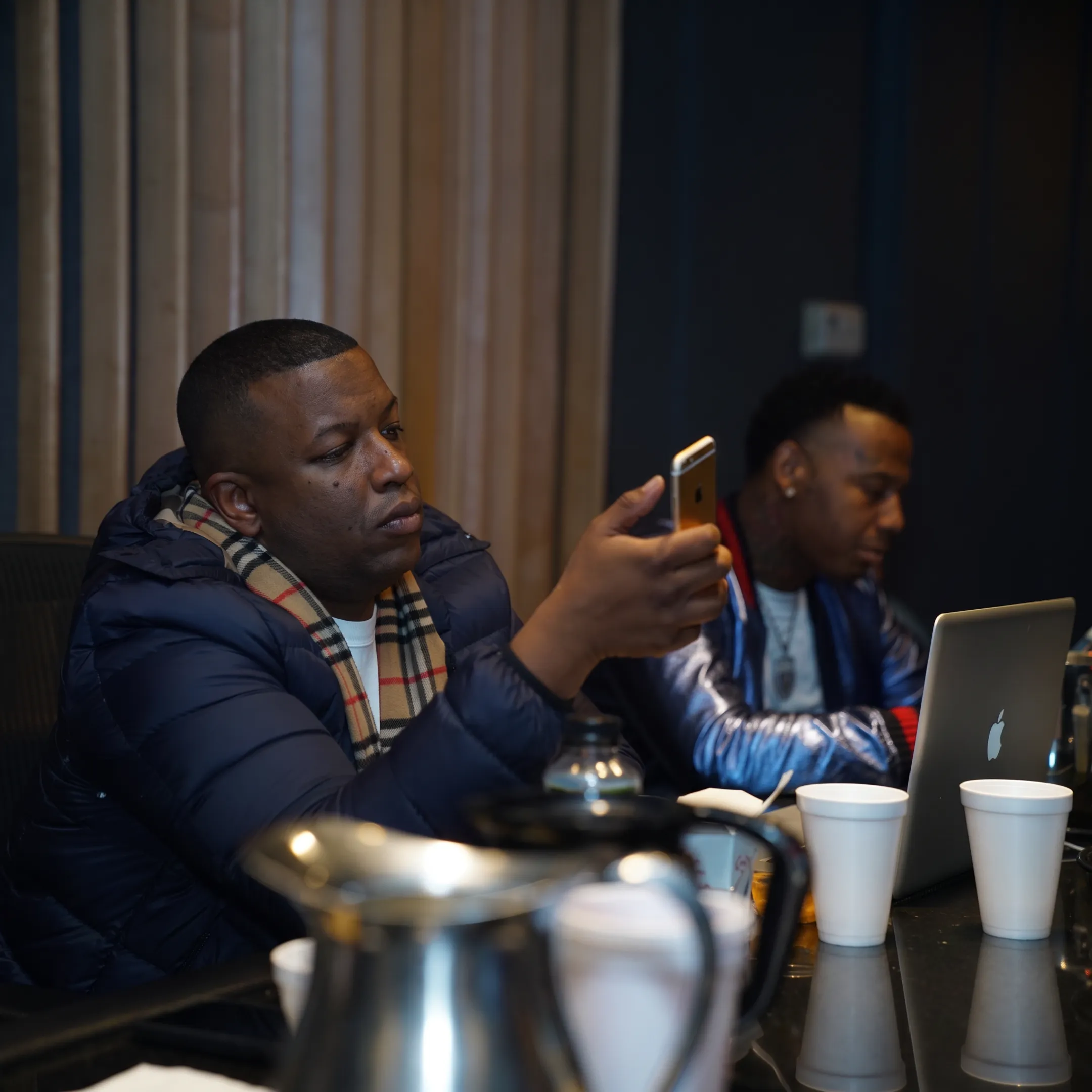 Music manager meeting with recording artist in a professional studio