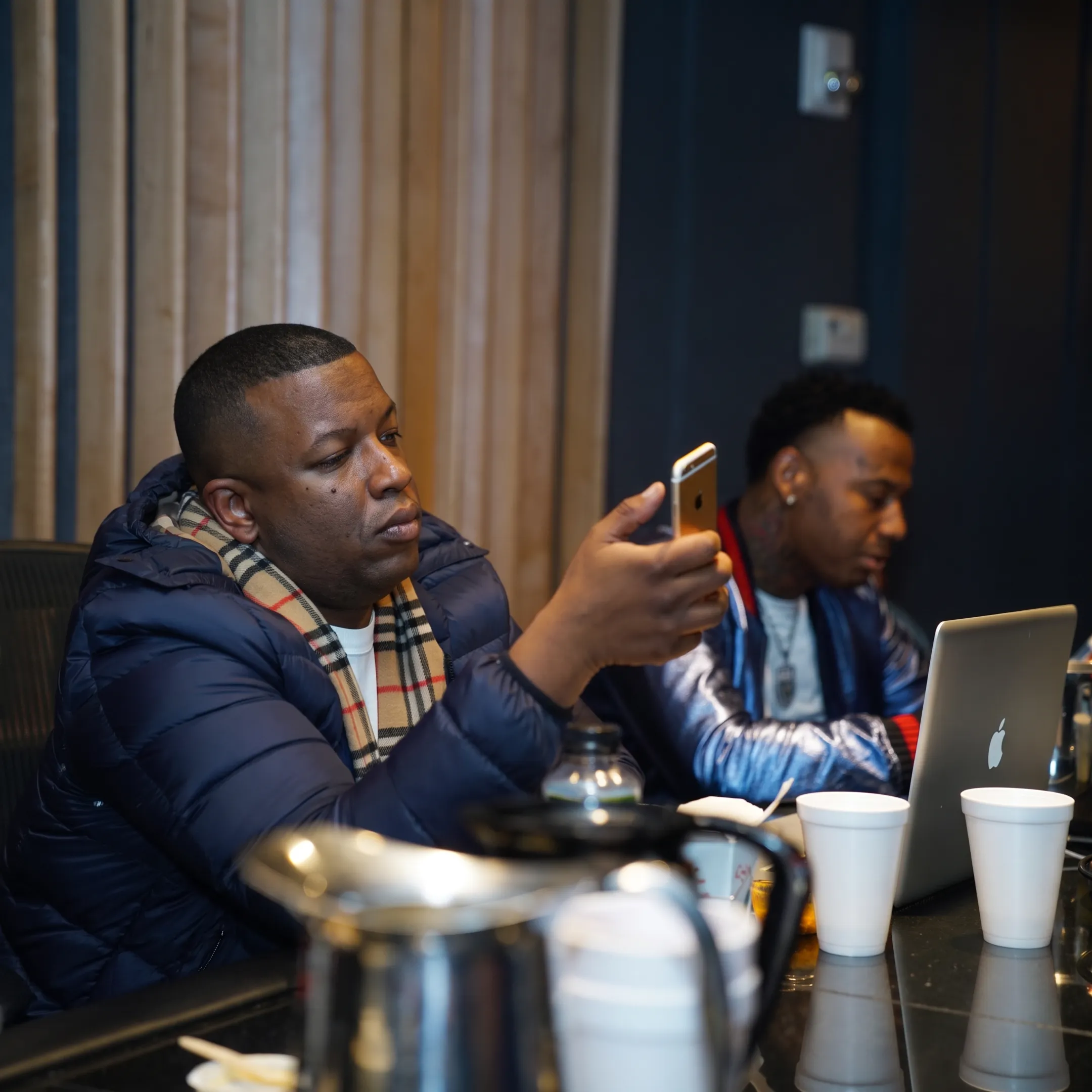 Artist and music manager discussing career plans in a recording studio