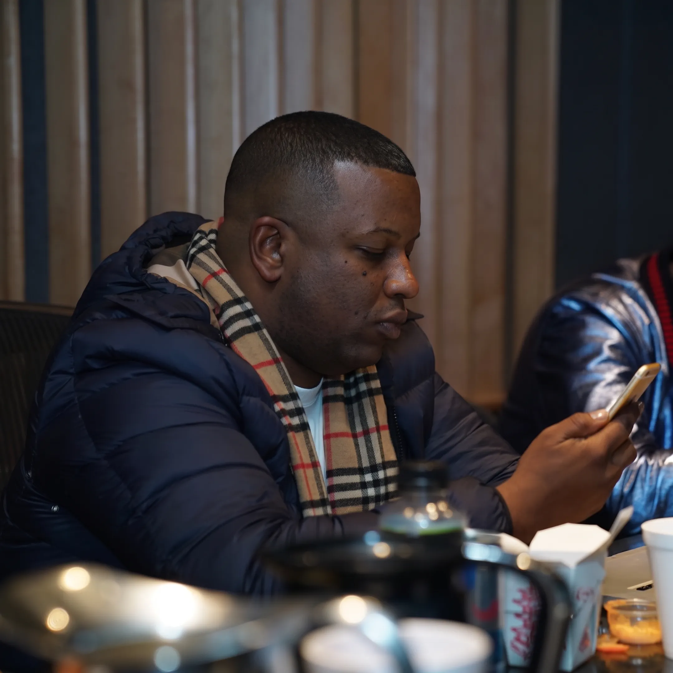 Artist and manager discussing music career plans beside studio equipment