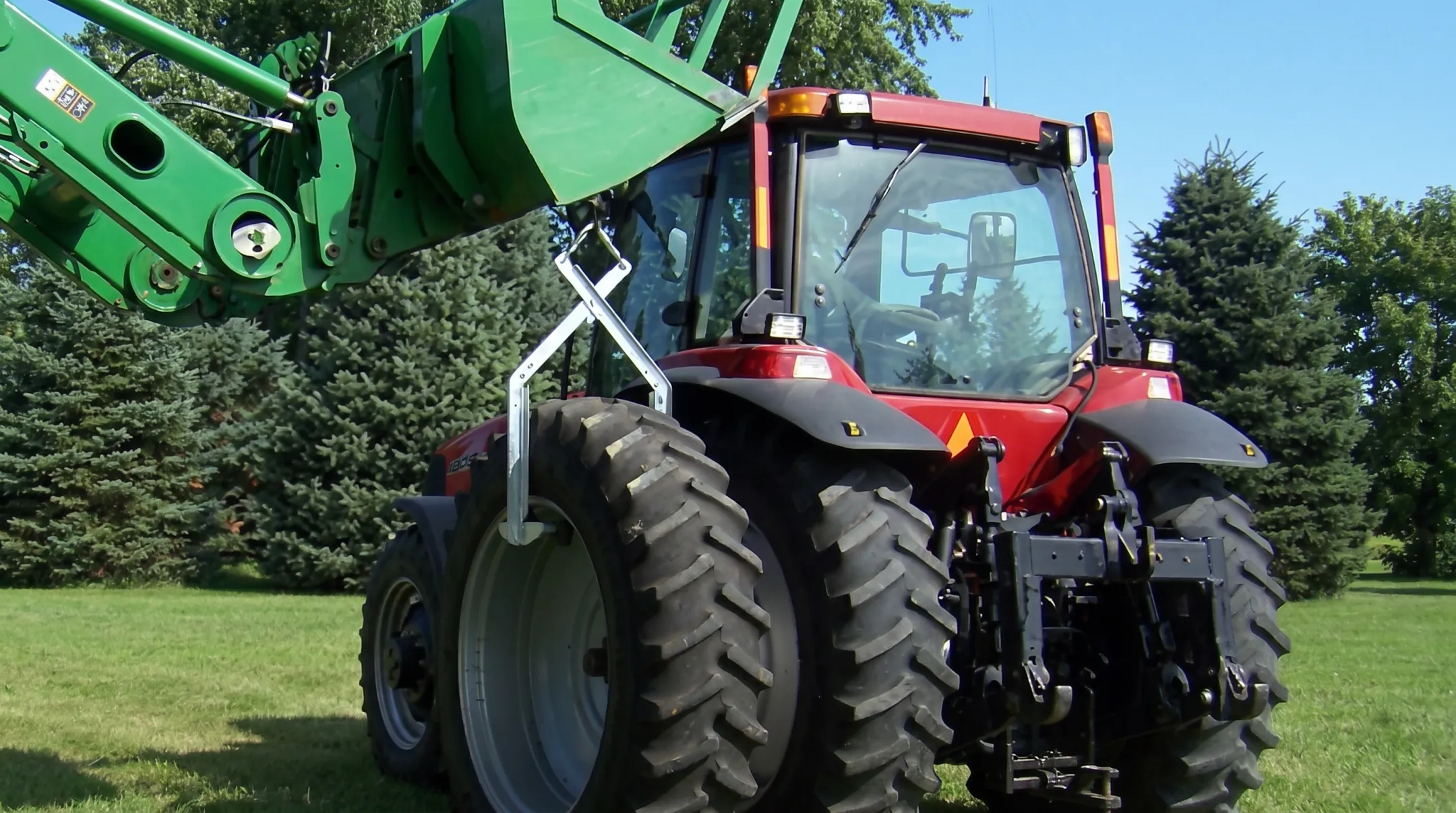 EZ Dual Changer tool safely lifting large agricultural tractor tire