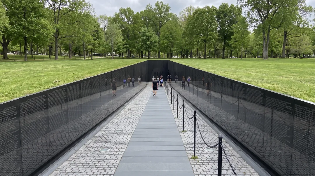 Vietnam Veterans Memorial black granite wall cut into earth