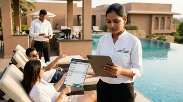 Hotel staff using mobile POS tablet to take poolside guest orders at resort