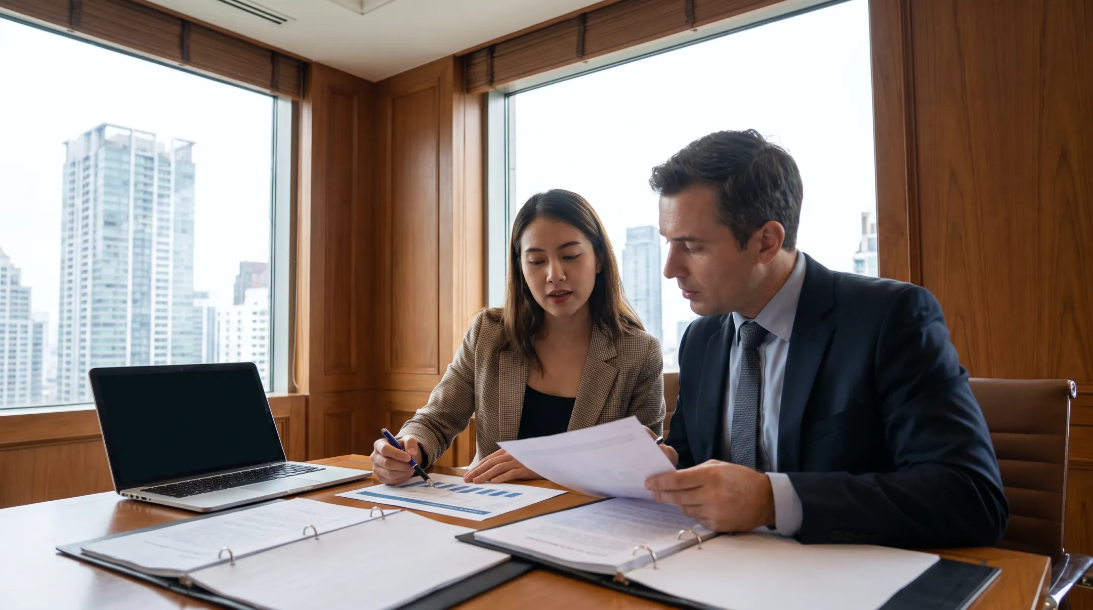 Business valuator reviewing ownership interest analysis with client
