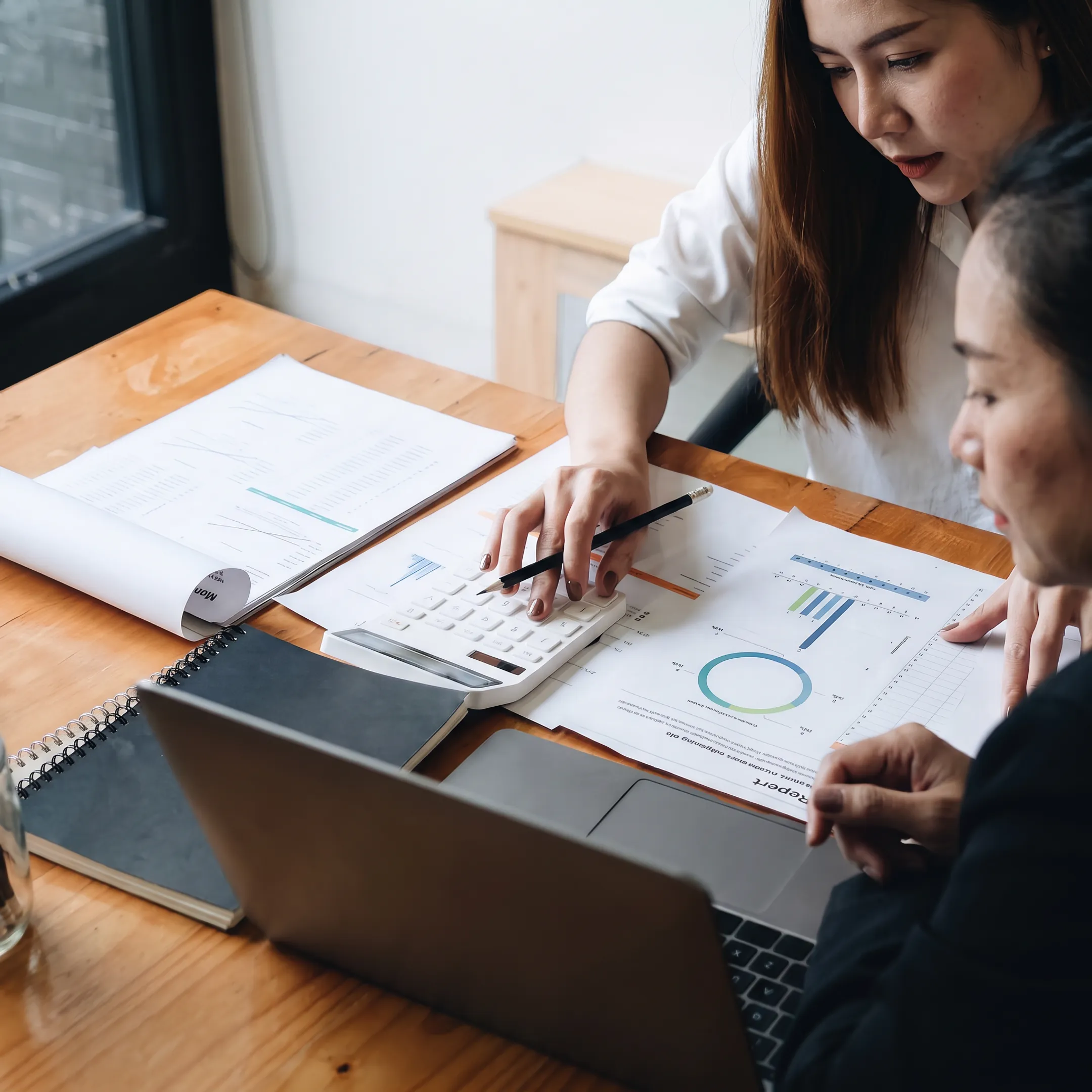 Valuation advisor reviewing corporate financial documents with a business owner
