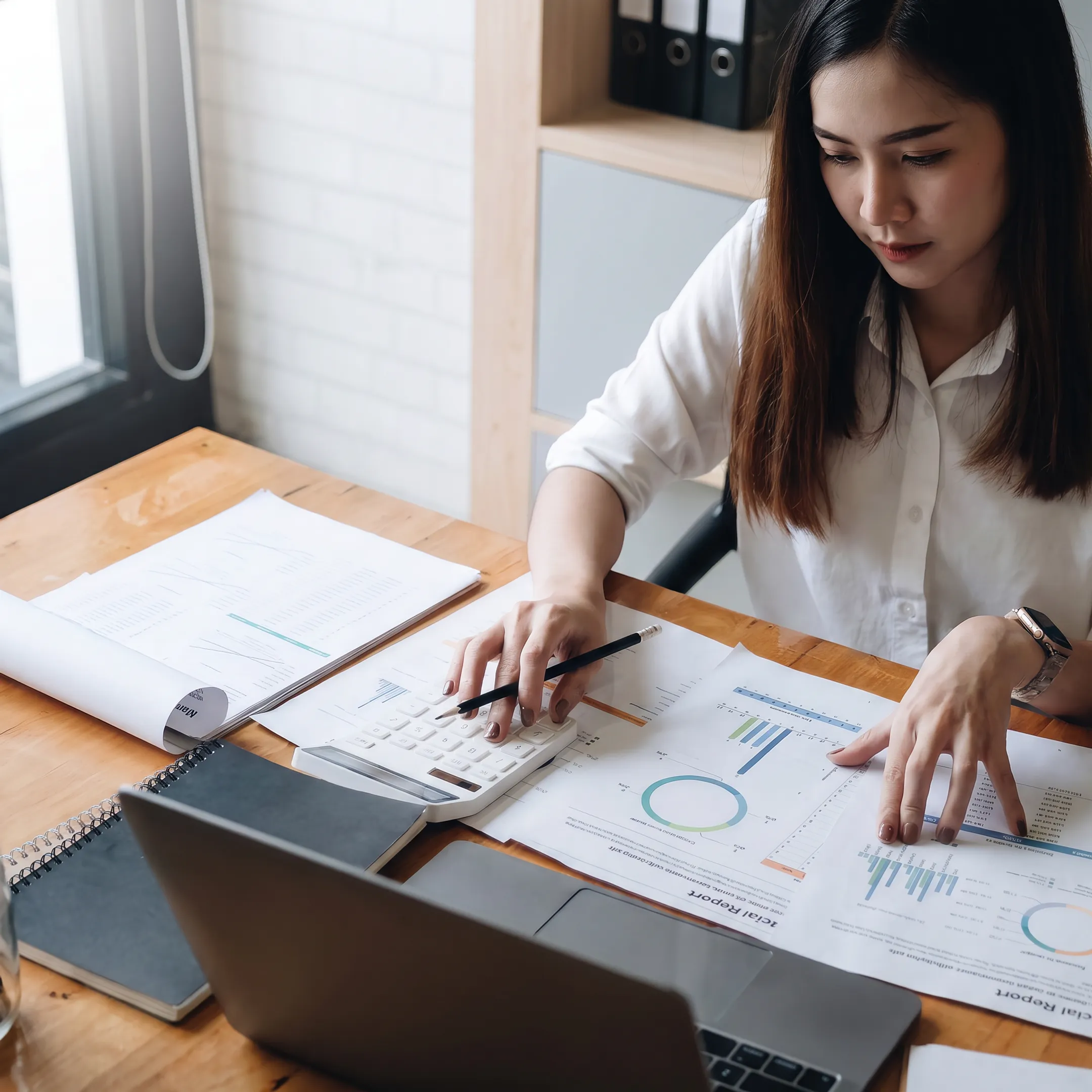 Valuation professional reviewing estate documents and private business financial records