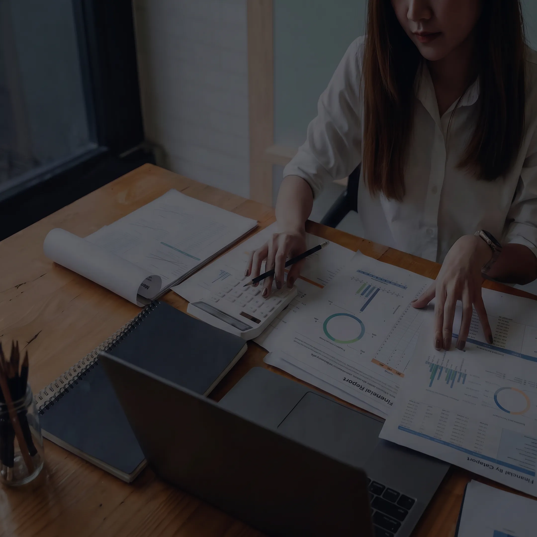 Advisor analyzing business valuation reports and transaction documents