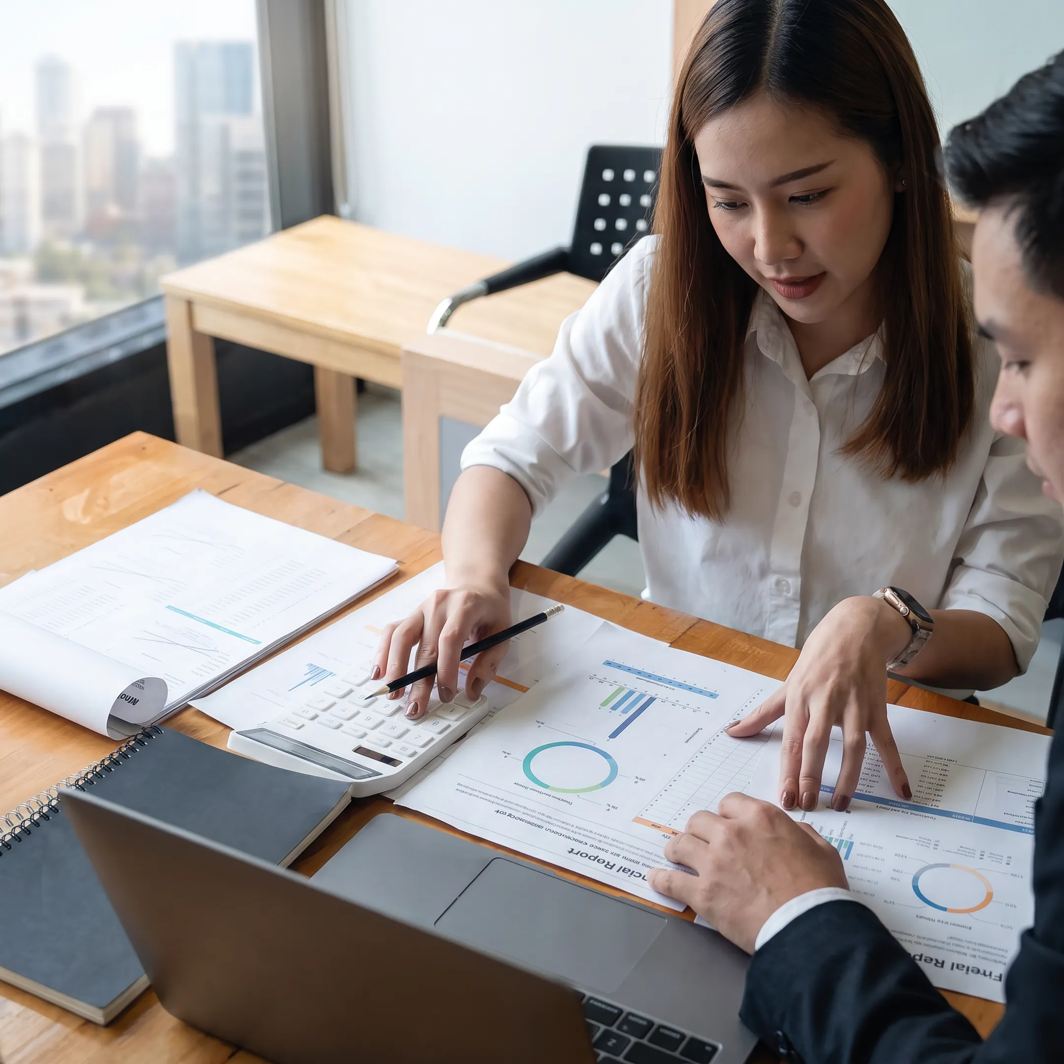 Valuation professional reviewing business financial documents with a client