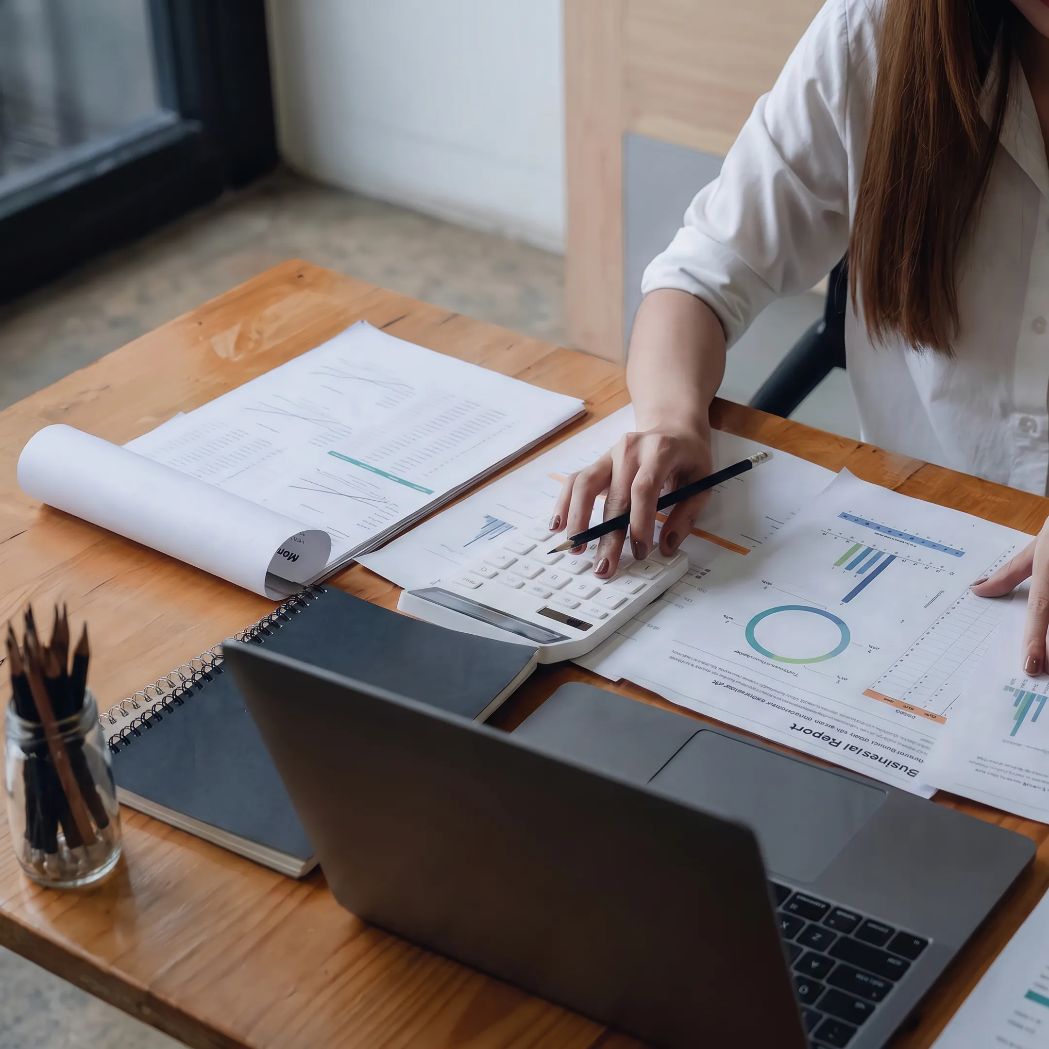 Valuator reviewing estate tax documents and business valuation records at a desk