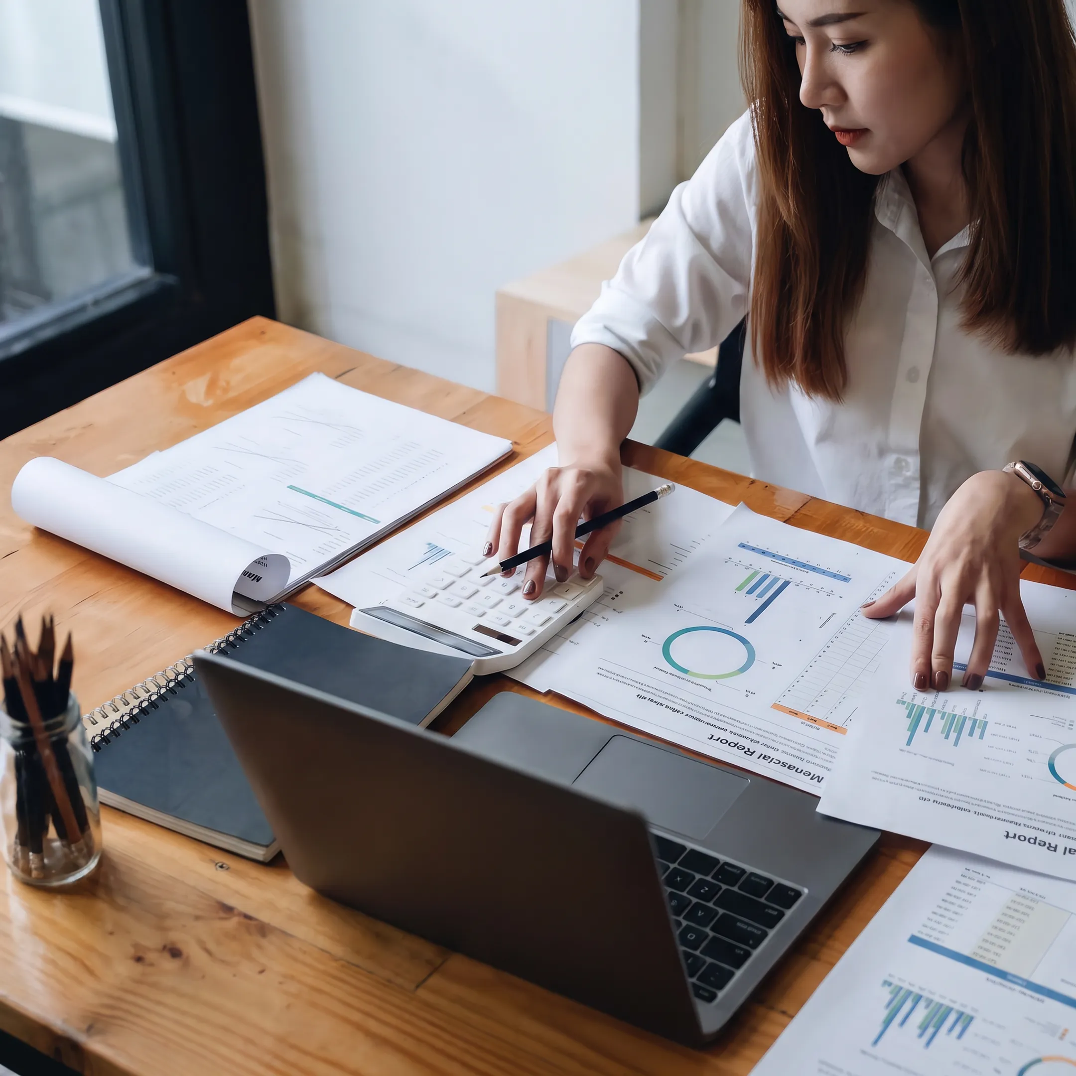Advisor analyzing business valuation reports and financial records