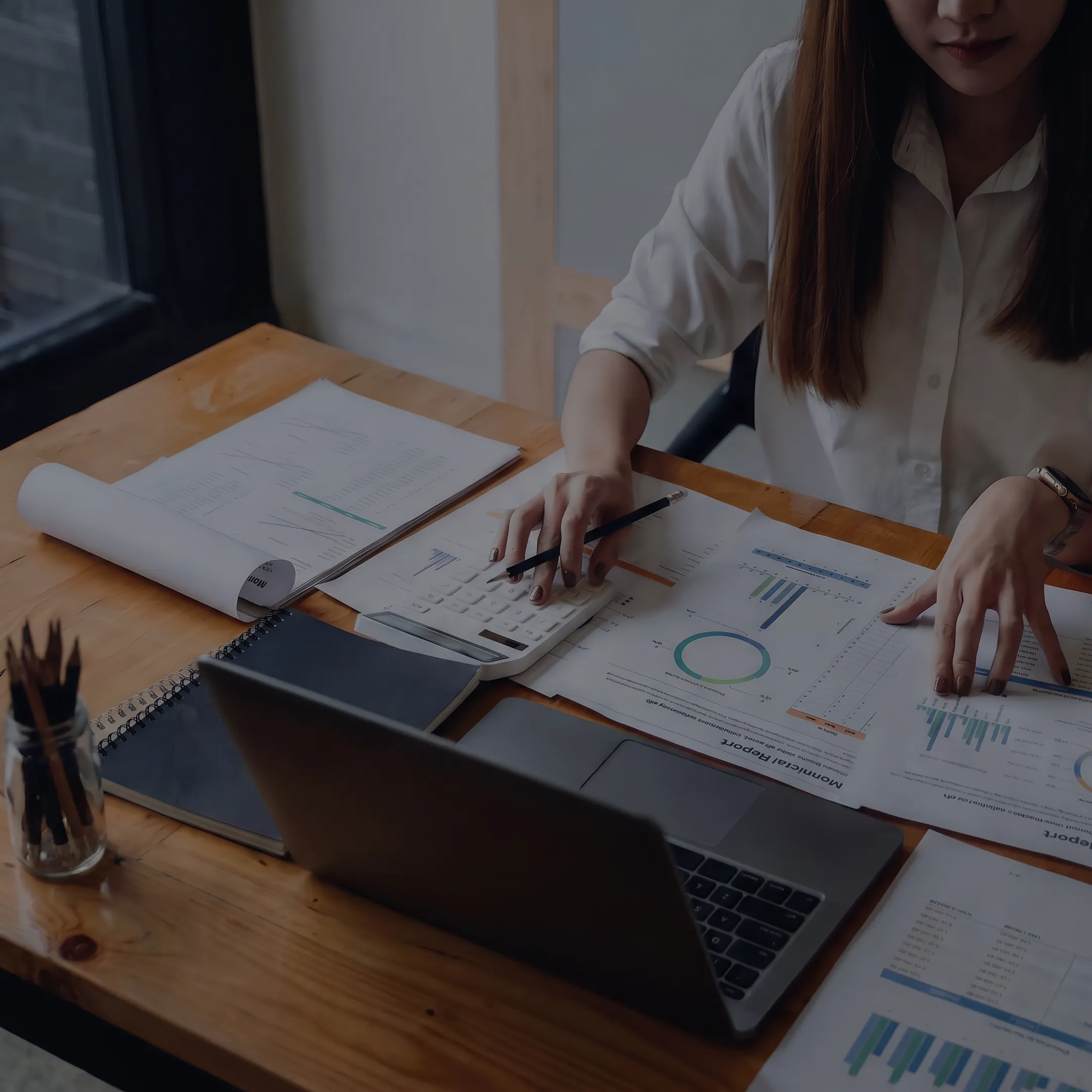 Valuation professional reviewing business appraisal documents at a desk