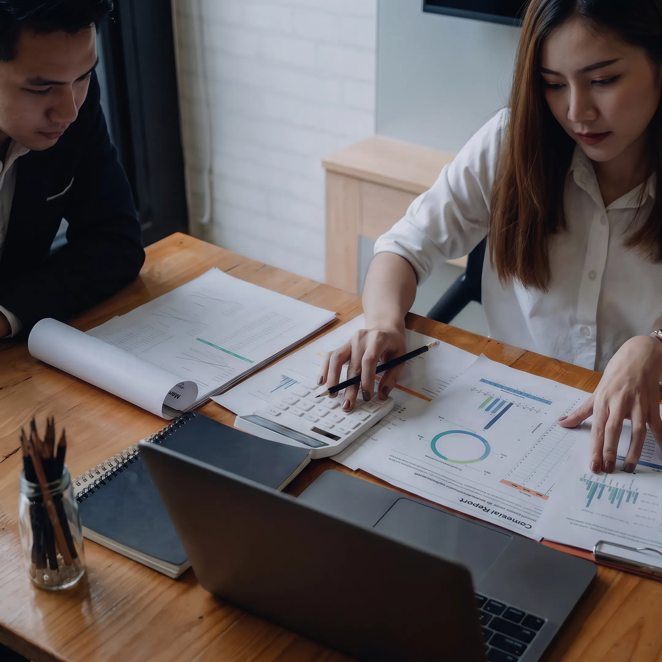 Valuation professional reviewing business financial documents with a broker