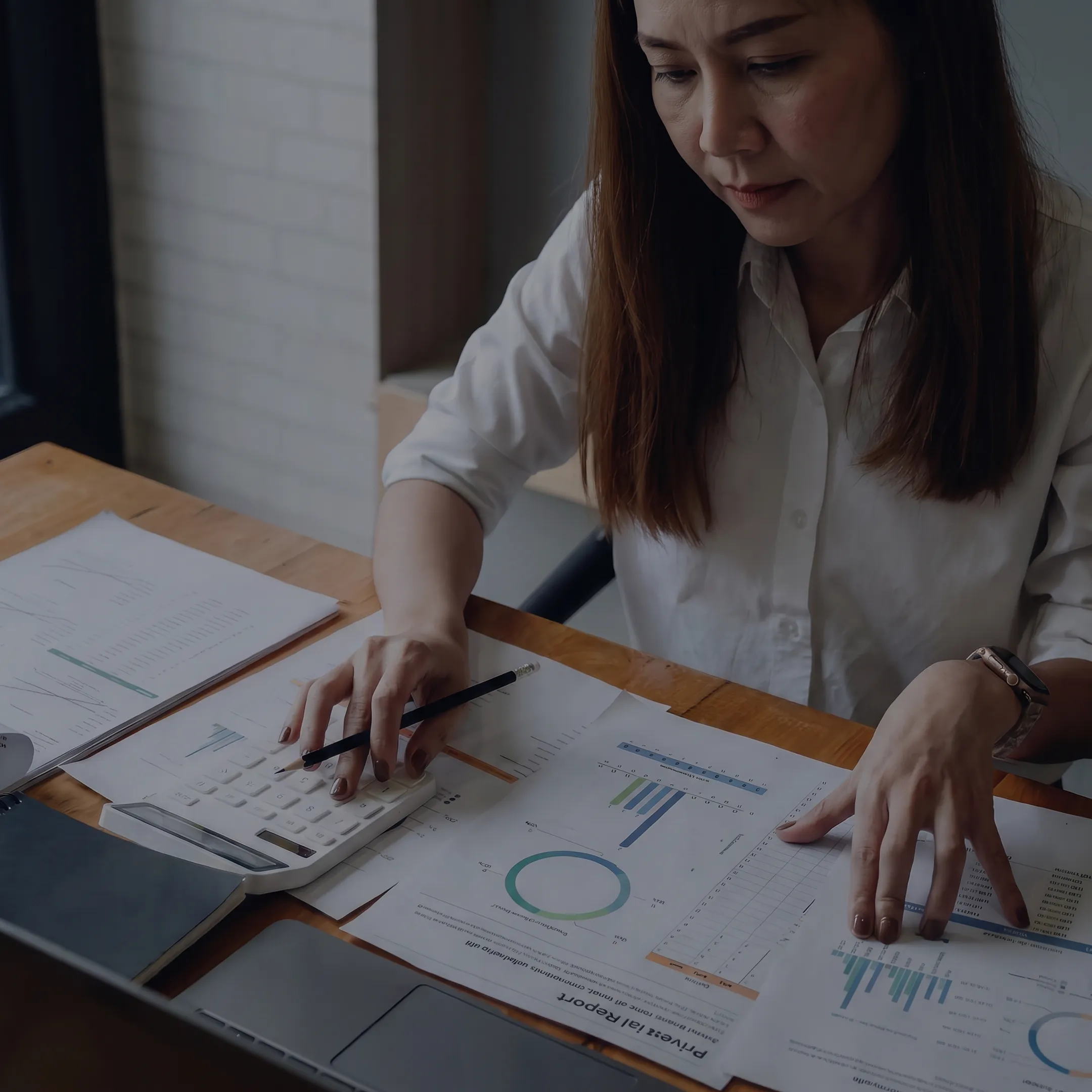 Valuation professional reviewing private company share analysis with business documents