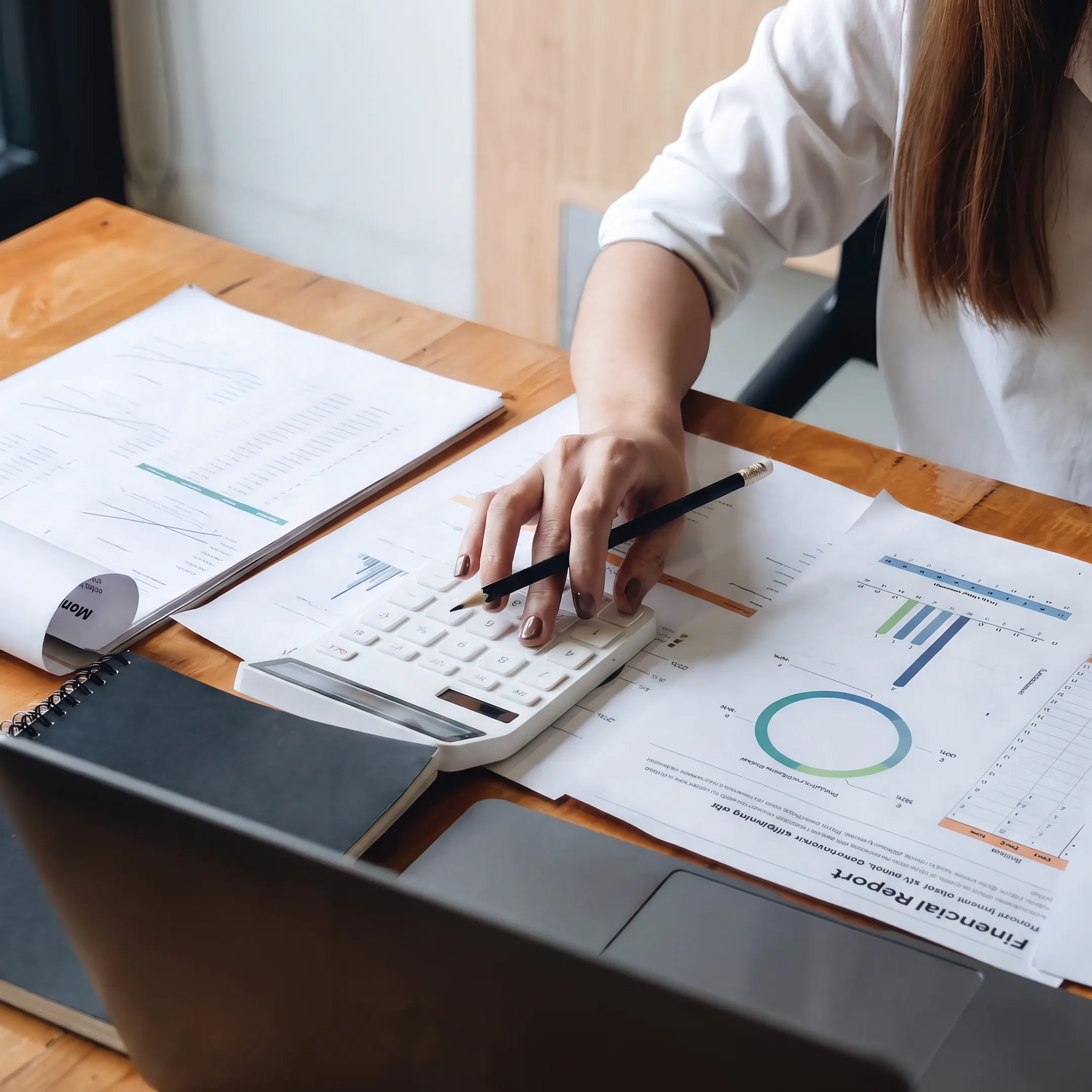 Valuation professional reviewing business financial documents and appraisal analysis