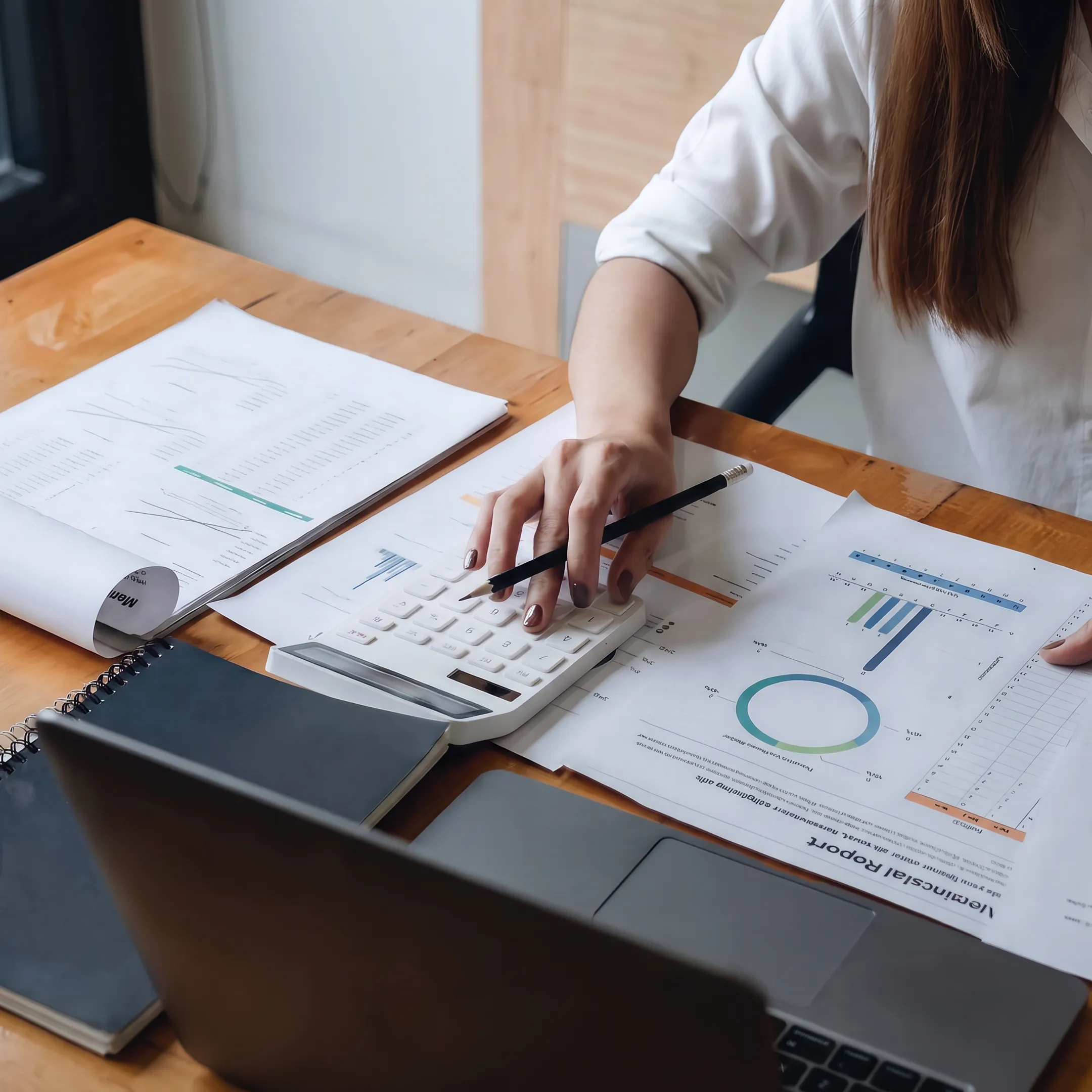 Valuation consultant reviewing a closely held business report with financial documents